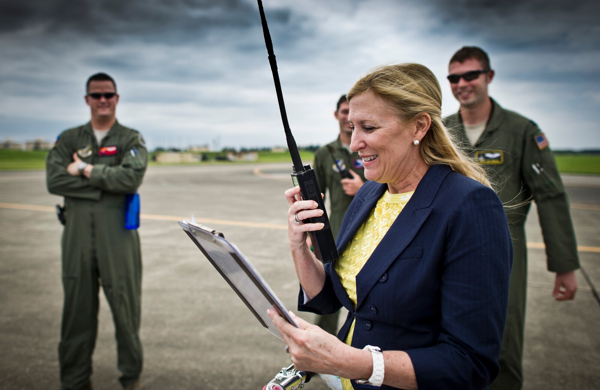 YOKOTA AIR BASE, Japan -- Lisa Field, wife of Lt. Gen. Burton Field, gives the current weather conditions over a land mobile radio for a practice cargo drop over Yokota Air Base, Japan, July 22, 2011. General Field, U.S. Forces, Japan, and 5th Air Force commander, flew on the aircraft during the drop to learn more about the C-130 mission. (U.S. Air Force photo/Staff Sgt. Samuel Morse)