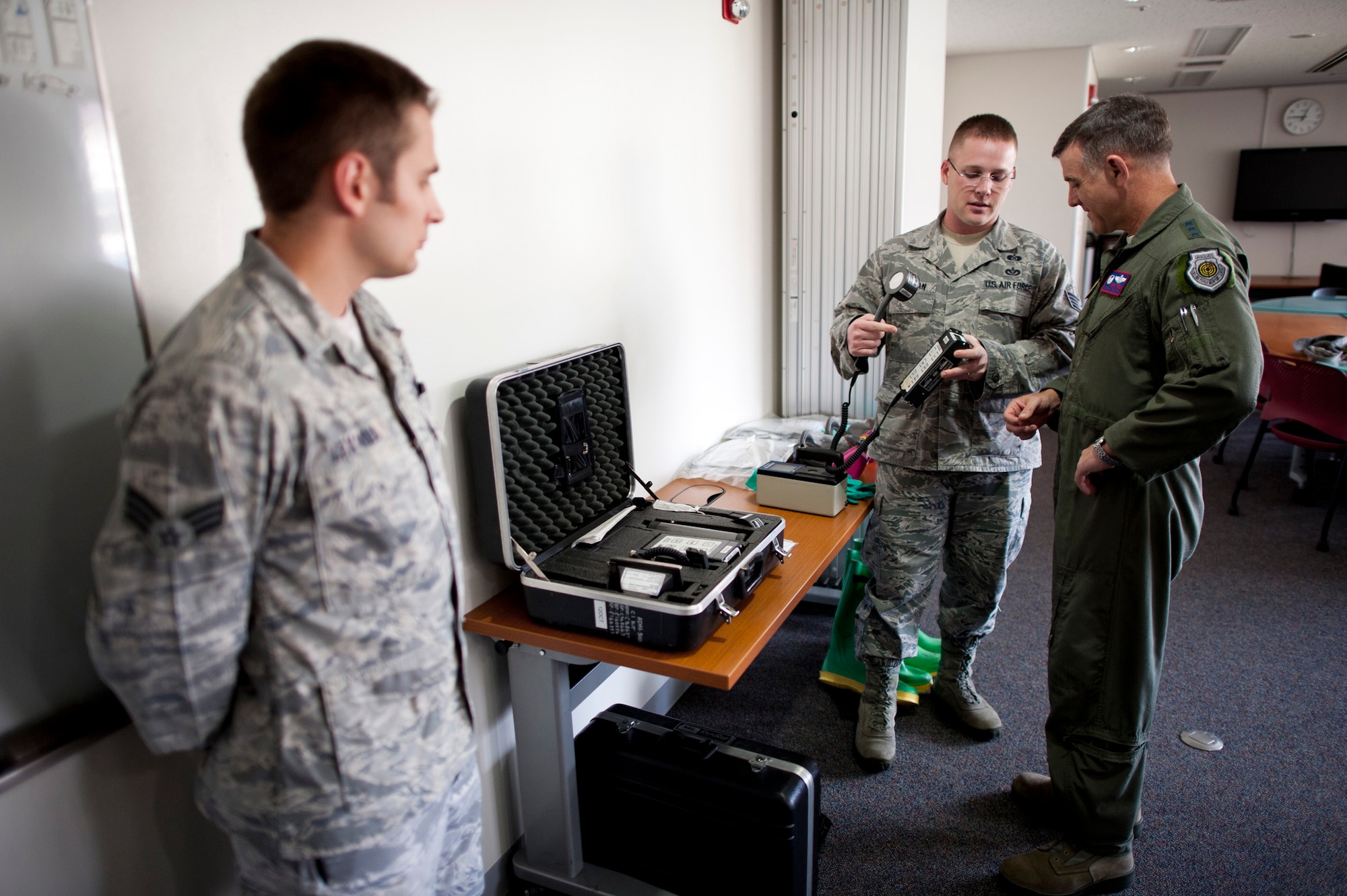 YOKOTA AIR BASE, Japan -- Staff Sgt. Craig Ackerman, 374th Civil Engineer Squadron NCO in charge of emergency management training, shows various tools used to scan aircraft and personnel for radiation to Lt. Gen. Burton Field, U.S. Forces, Japan, and 5th Air Force commander, at Yokota Air Base, Japan, July 22, 2011. The 374th CES and 374th Aerospace Medicine Squadron worked together during Operation Tomodachi to keep Yokota safe from potential radiation. (U.S. Air Force photo/Staff Sgt. Samuel Morse)