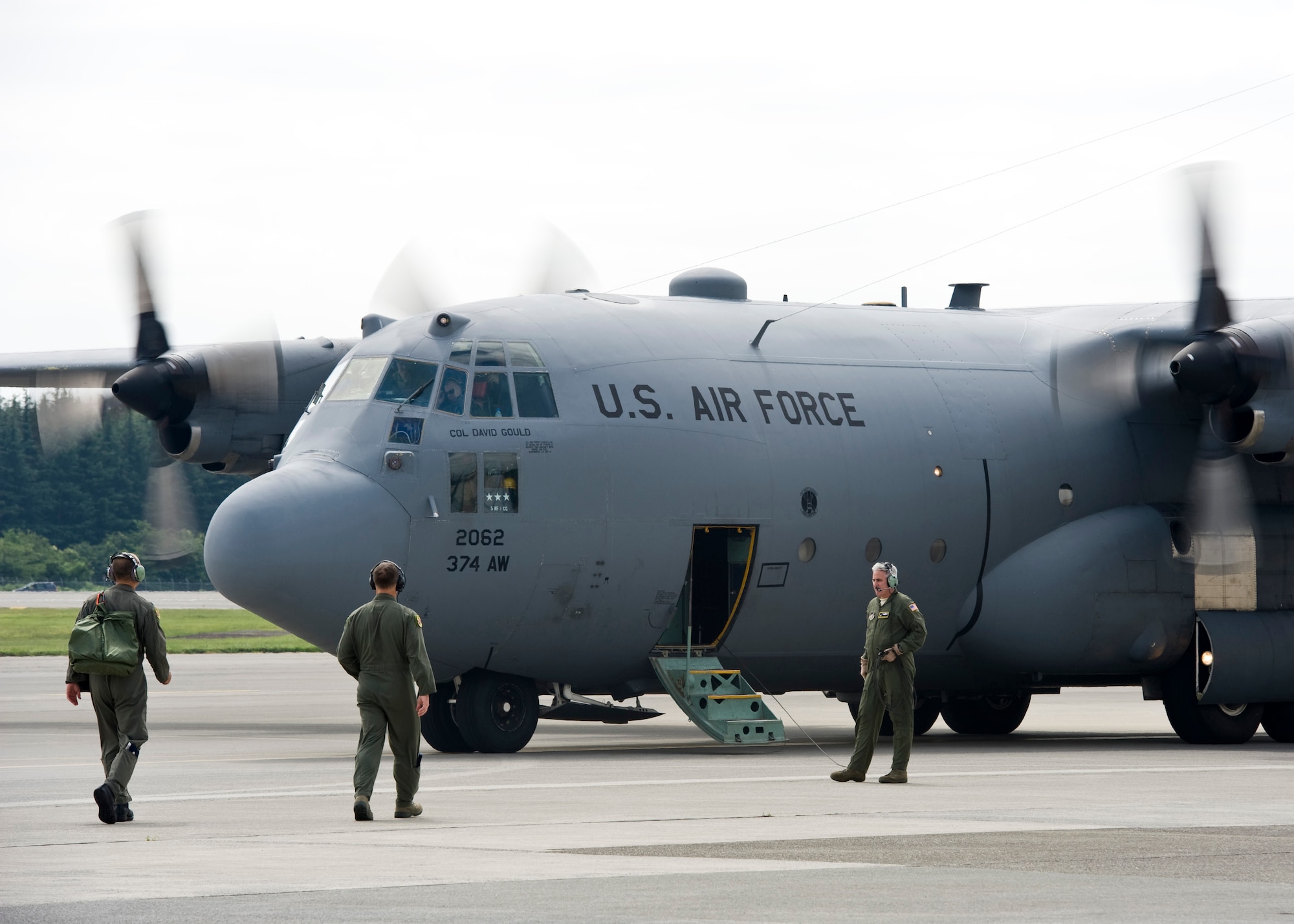 YOKOTA AIR BASE, Japan -- Lt. Gen. Burton Field, U.S. Forces, Japan, and 5th Air Force commander and aircrew members walk toward a C-130 Hercules July 22, 2011, at Yokota Air Base, Japan. General Field flew on the aircraft to learn more about the C-130 mission and the role the aircraft played during Operation Tomodachi. (U.S. Air Force photo/Senior Airman Andrea Salazar)