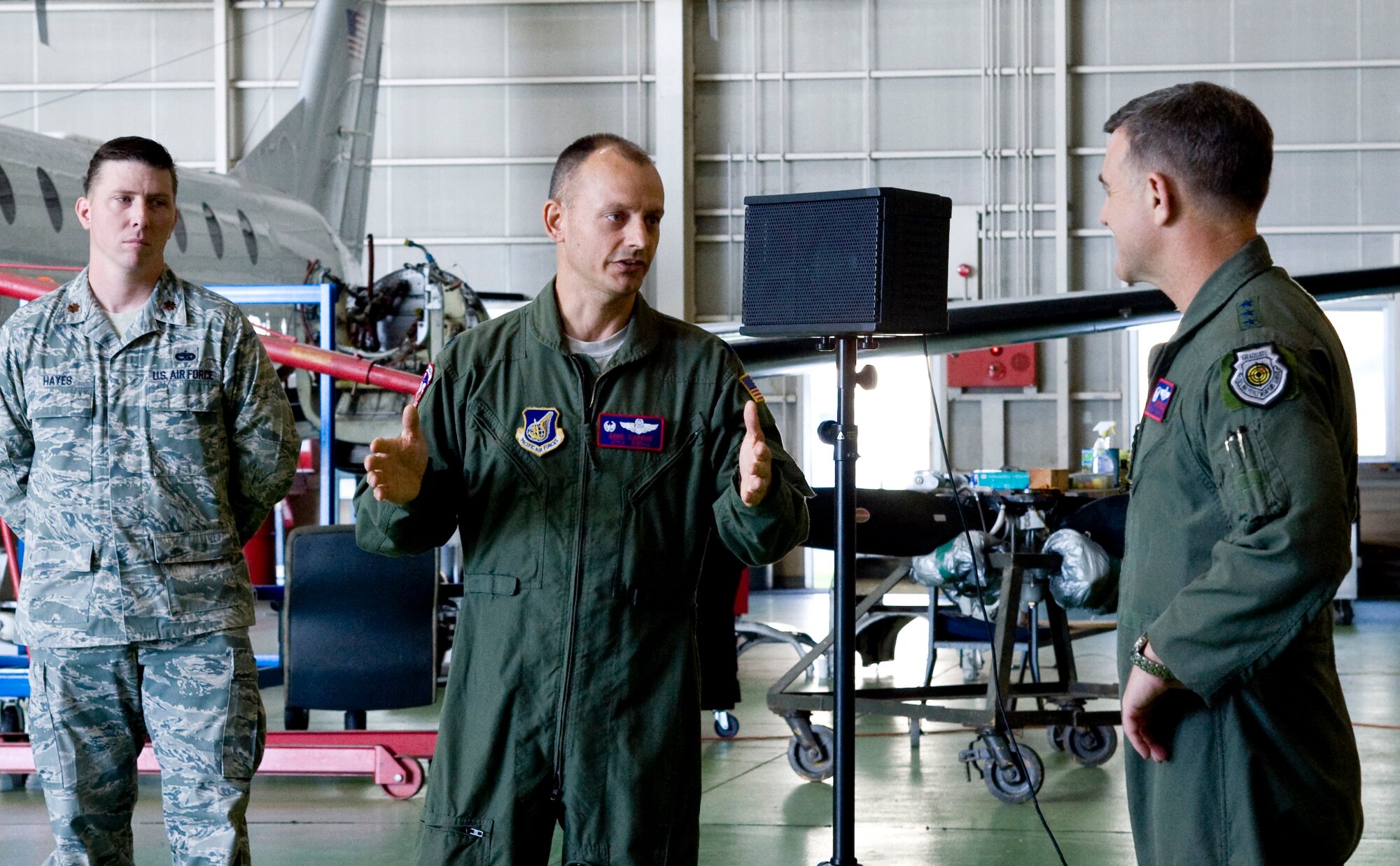 YOKOTA AIR BASE, Japan -- Lt. Col. Eugene Capone (center), 459th Airlift Squadron commander, talks with Lt. Gen. Burton Field, U.S. Forces, Japan, and 5th Air Force commander, July 22, 2011, inside the 459th AS hangar, Yokota Air Base, Japan.  Colonel Capone and General Field discussed the various mission challenges and accomplishments aircrew members encountered during Operation Tomodachi. (U.S. Air Force photo/Senior Airman Andrea Salazar)