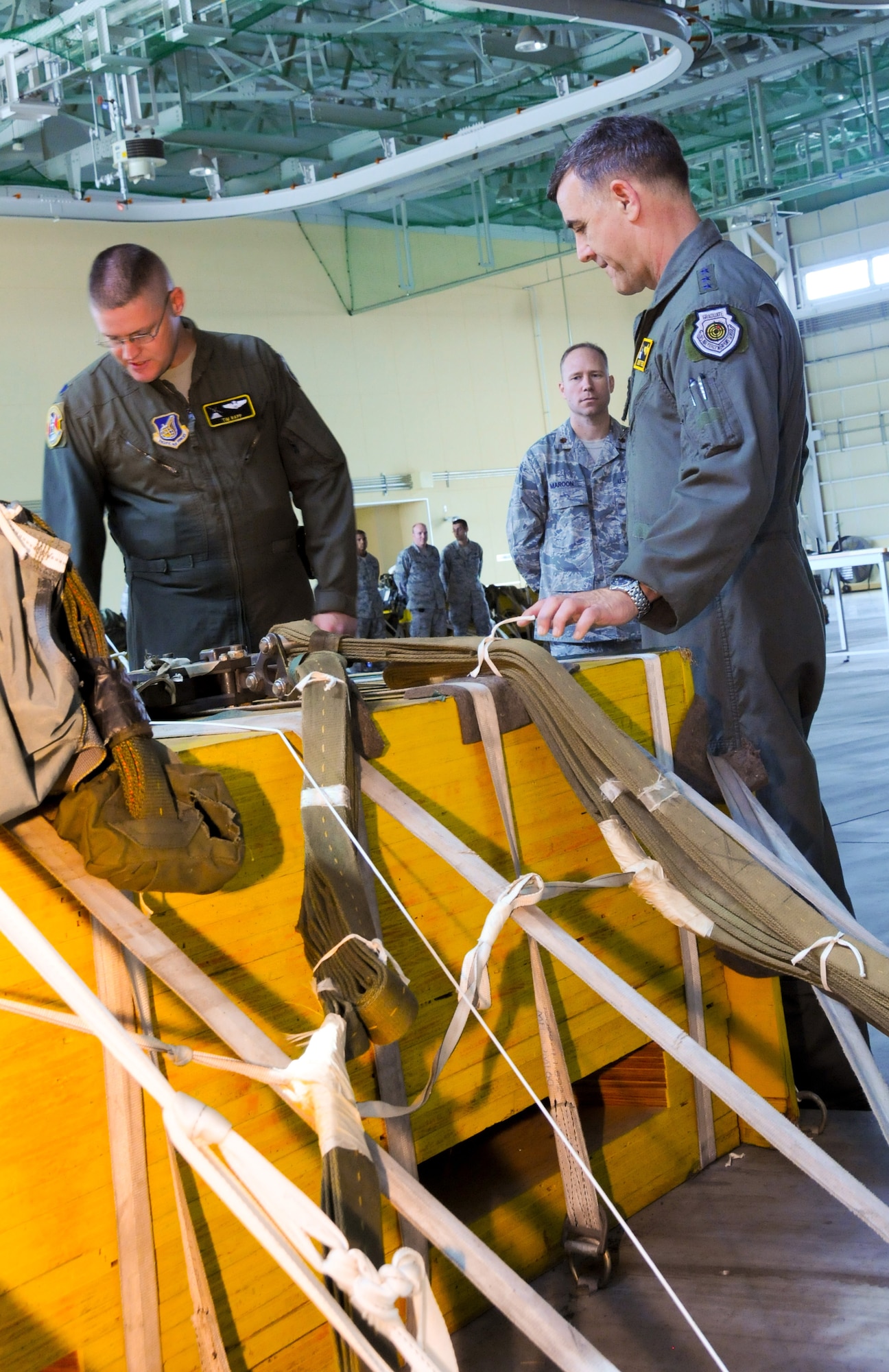 YOKOTA AIR BASE, Japan -- Lt. Col. Timothy Rapp (left), 36th Airlift Squadron commander, explains the inner workings and significance of a simulated heavy equipment load for airdrop training to Lt. Gen. Burton Field, U.S. Forces, Japan, and 5th Air Force commander, at Yokota Air Base, Japan, July 22, 2011. (U.S. Air Force photo/Airman 1st Class Krystal M. Garrett)