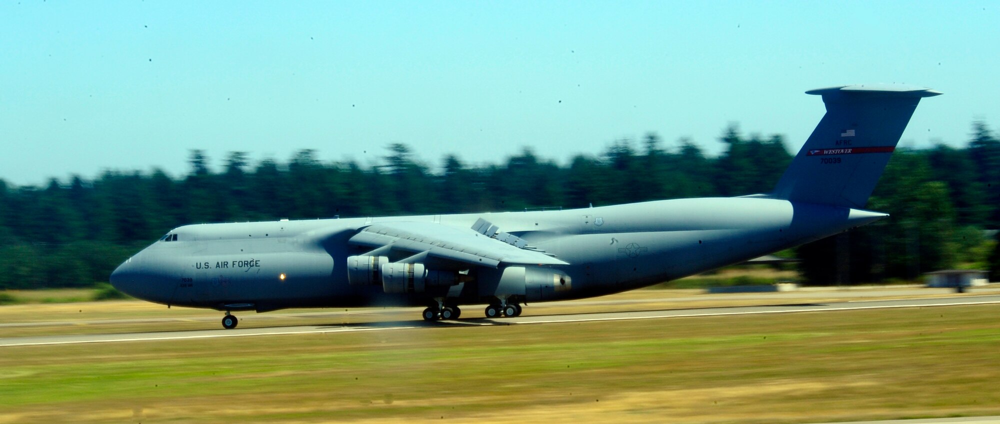 A C-5 Galaxy from the 439th Airlift Wing lands at Joint Base Lewis-McChord, Wash., July 23, 2011, to partcipate in Air Mobility Rodeo 2011. Rodeo is a biennial international competition that focuses on mission readiness, featuring airdrops, aerial refueling and other events that showcase the skills of mobility crews from around the world. The 439th AW hails from  Westover Air Reserve Base, Mass. (U.S. Air Force photo/Staff Sgt. J.G. Buzanowski)