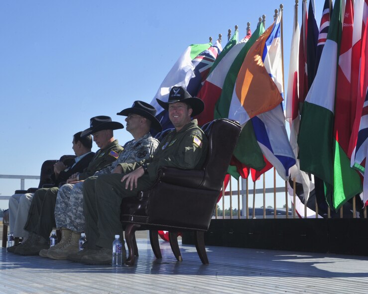 Col. R. Wyn Elder, 62nd Airlift Wing commander, listens as Gen. Raymond Johns
Jr., AMC commander, speaks during the opening ceremony for Air Mobility
Command's 2011 Rodeo July 24 at Joint Base Lewis-McChord, Wash. (U.S. Air
Force Photo/Staff Sgt. Frances Kriss)
