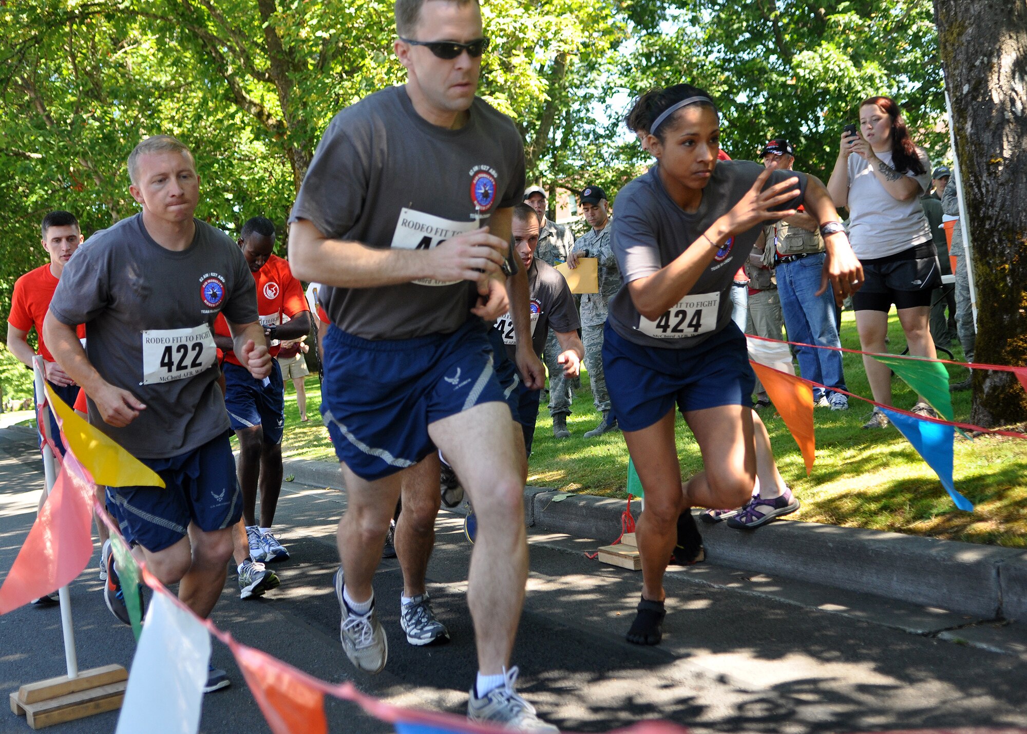 Airmen representing the 62nd Airlift Wing and 627th Air Base Group Rodeo team begin the 1.5 mile run portion of the ‘Fit to Fight’ challenge July 24, 2011, at Joint Base Lewis-McChord, Wash. The challenge consisted of a run and one minute of both push-ups and sit-ups. The physical challenge is just one aspect of Air Mobility Rodeo 2011, a biennial international competition that focuses on mission readiness, featuring airdrops, aerial refueling and other events that showcase the skills of mobility crews from around the world. (U.S. Air Force photo/Airman 1st Class Leah Young)
