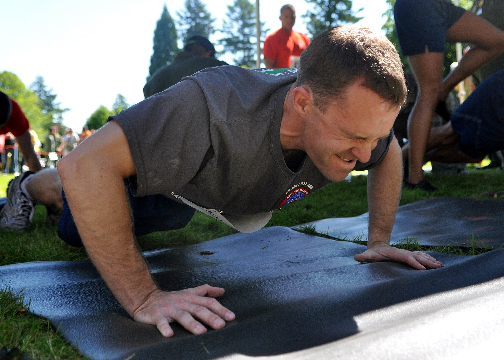 Capt. Barry McKeown, 62nd Airlift Rodeo team member, finishes his last push-up of the ‘Fit to Fight’ challenge July 24, 2011, at Joint Base Lewis-McChord, Wash. The challenge consisted of a 1.5 mile run and one minute of both push-ups and sit-ups. The physical challenge is just one aspect of Air Mobility Rodeo 2011, a biennial international competition that focuses on mission readiness, featuring airdrops, aerial refueling and other events that showcase the skills of mobility crews from around the world. (U.S. Air Force photo/Airman 1st Class Leah Young)