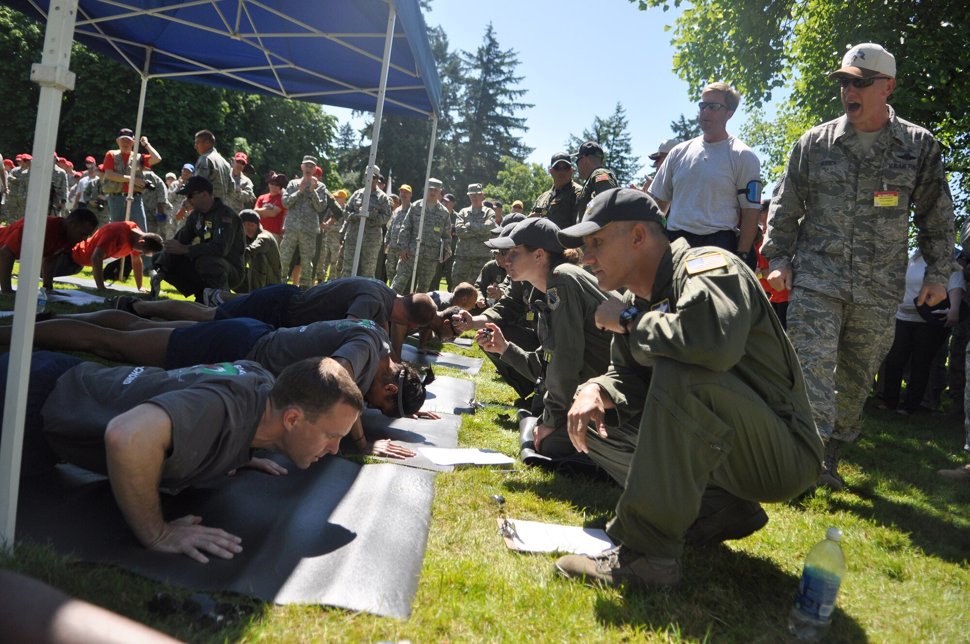 62nd Airlift Wing leadership cheer on Airmen representing the 62nd Airlift Wing and 627th Air Base Group Rodeo team before the ‘Fit to Fight’ challenge July 24, 2011, at Joint Base Lewis-McChord, Wash. The challenge consisted of a 1.5 mile run and one minute of both push-ups and sit-ups. The physical challenge is just one aspect of Air Mobility Rodeo 2011, a biennial international competition that focuses on mission readiness, featuring airdrops, aerial refueling and other events that showcase the skills of mobility crews from around the world. (U.S. Air Force photo/Airman 1st Class Leah Young)