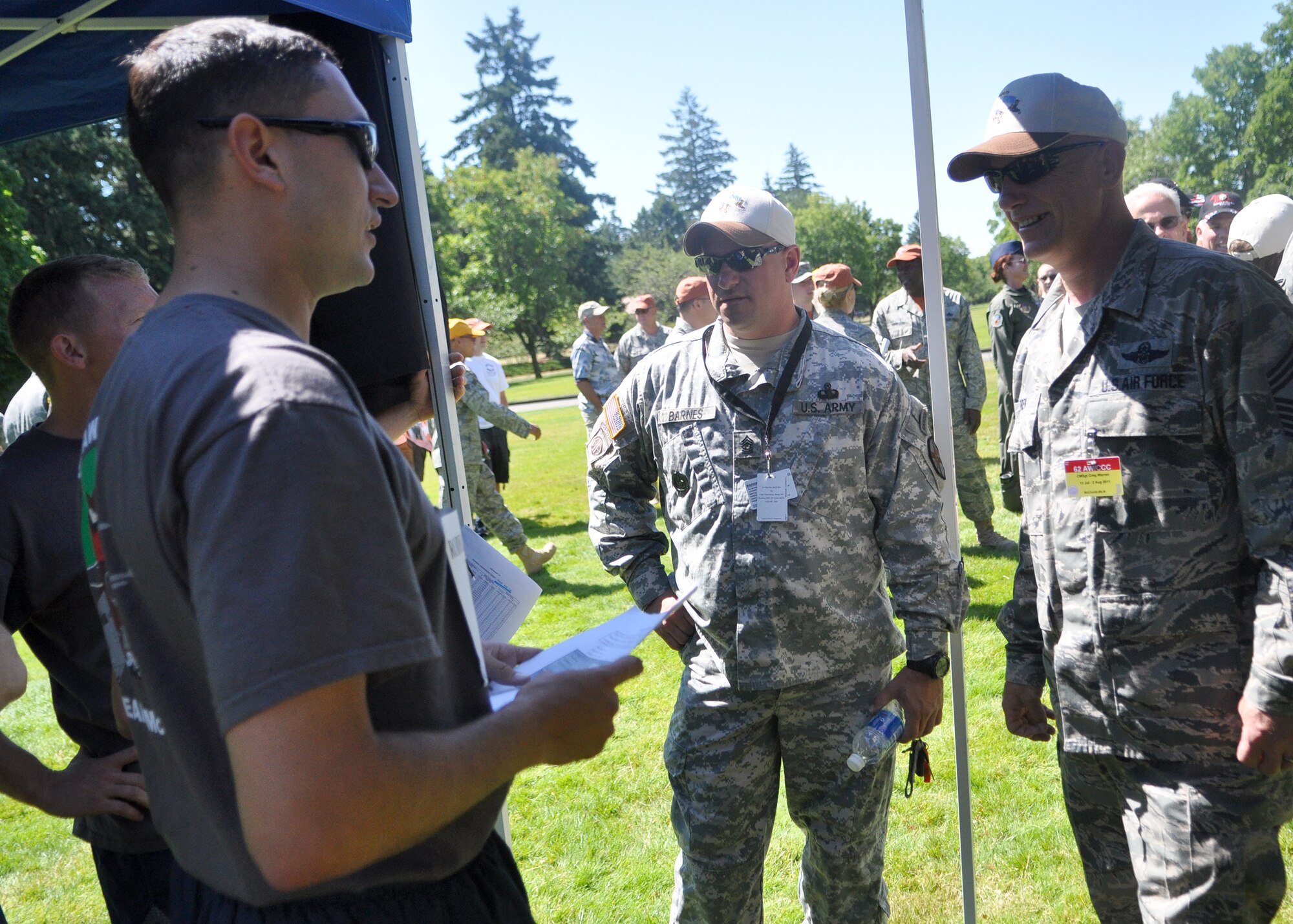 Gregory Warren, far right, 62nd Airlift Wing command chief, and Matthew Barnes, middle, Joint Base Lewis-McChord Garrison command sergeant major, speak to Airmen representing the 62nd Airlift Wing and 627th Air Base Group Rodeo team before the ‘Fit to Fight’ challenge July 24, 2011, at JBLM, Wash. The physical challenge is just one aspect of Air Mobility Rodeo 2011, a biennial international competition that focuses on mission readiness, featuring airdrops, aerial refueling and other events that showcase the skills of mobility crews from around the world. (U.S. Air Force photo/Airman 1st Class Leah Young)