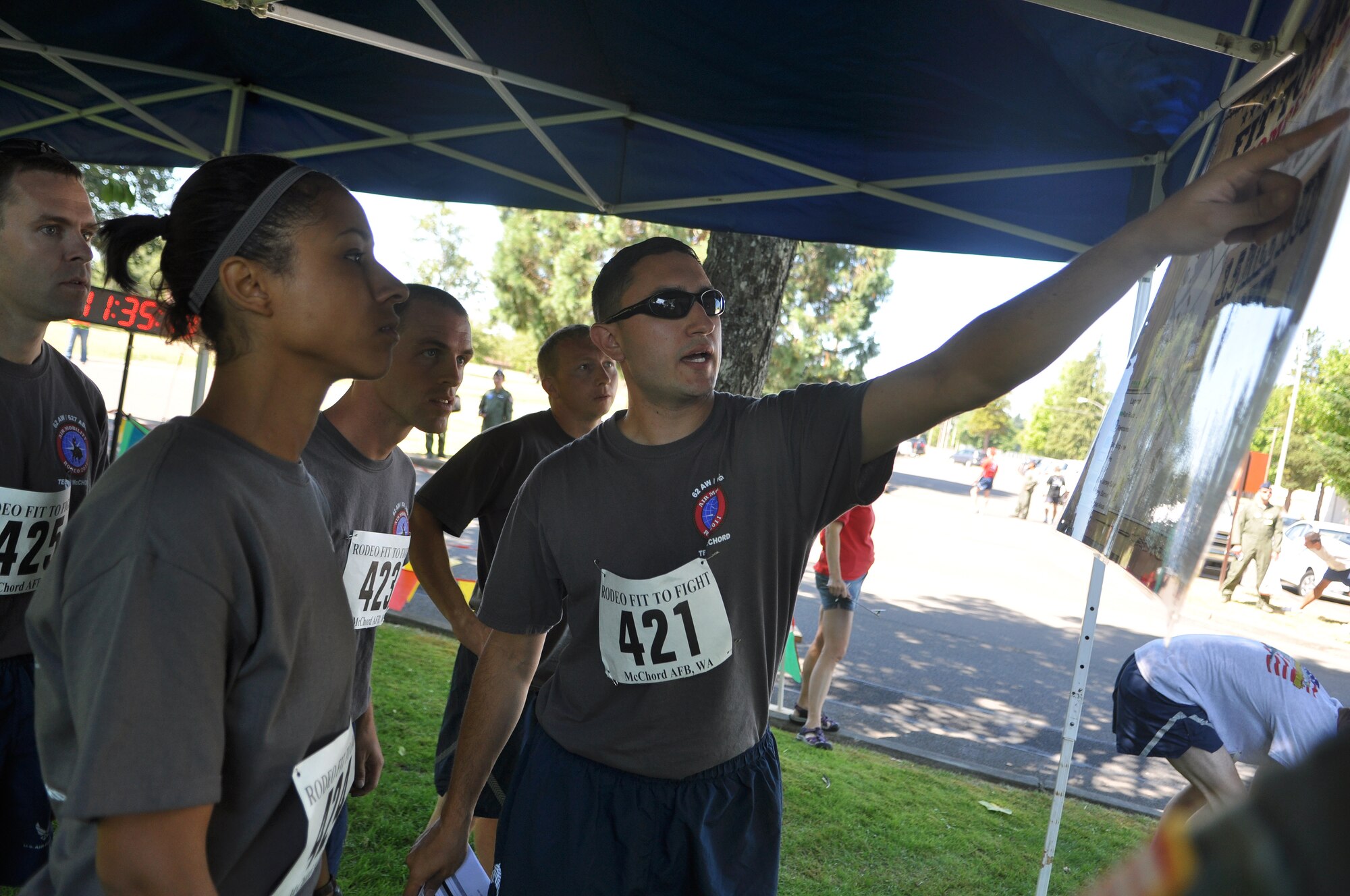 Airmen representing the 62nd Airlift Wing and 627th Air Base Group Rodeo team discuss the 1.5 mile run course before the ‘Fit to Fight’ challenge July 24, 2011, at Joint Base Lewis-McChord, Wash. The physical challenge is just one aspect of Air Mobility Rodeo 2011, a biennial international competition that focuses on mission readiness, featuring airdrops, aerial refueling and other events that showcase the skills of mobility crews from around the world. (U.S. Air Force photo/Airman 1st Class Leah Young)