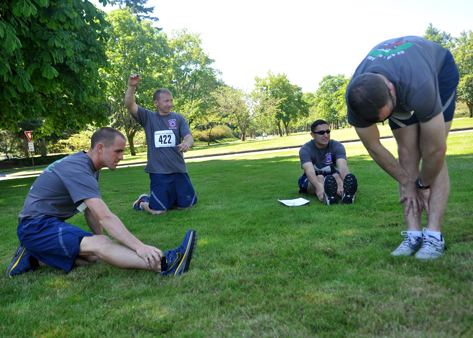 Airmen representing the 62nd Airlift Wing and 627th Air Base Group Rodeo team stretch before the ‘Fit to Fight’ challenge July 24, 2011, at Joint Base Lewis-McChord, Wash. The challenge consisted of a 1.5 mile run and one minute of both push-ups and sit-ups. The physical challenge is just one aspect of Air Mobility Rodeo 2011, a biennial international competition that focuses on mission readiness, featuring airdrops, aerial refueling and other events that showcase the skills of mobility crews from around the world. (U.S. Air Force photo/Airman 1st Class Leah Young)