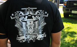 An Airman from Joint Base Charleston sports a Team Charleston Rodeo shirt designed to boost morale, July 24, 2011, at Joint Base Lewis-McChord, Wash. Air Mobility Rodeo 2011 is a biennial international competition that focuses on mission readiness, featuring airdrops, aerial refueling and other events that showcase the skills of mobility crews from around the world. (U.S. Air Force Photo/Airman 1st Class Jared Trimarchi) 