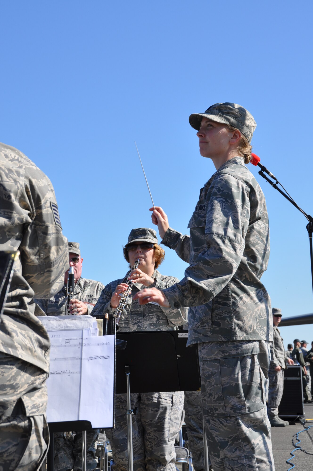 Capt. Haley Armstrong, U.S. Air Force Band of the Golden West commander, conducts the band during the opening ceremonies of the Air Mobility Rodeo 2011 July 24 at Joint Base Lewis-McChord, Wash. Air Mobility Rodeo 2011 is a biennial international competition that focuses on mission readiness, featuring airdrops, aerial refueling and other events that showcase the skills of mobility crews from around the world. (U.S. Air Force photos/Airman 1st Class Michael Battles