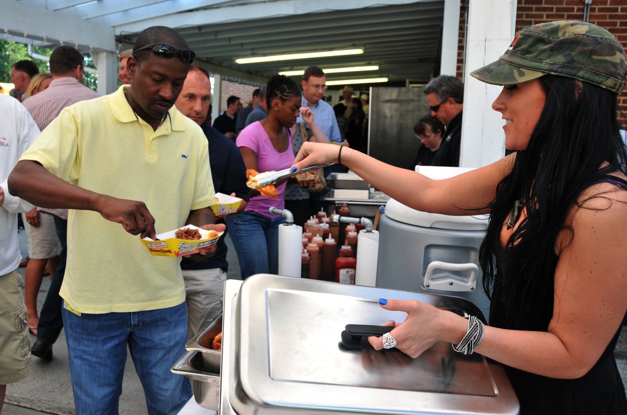 People line up for food at the LeMay Museum in Tacoma, Wash.,on July 23, 2011, during an icebreaker event for participants in Air Mobility Rodeo 2011 at Joint Base Lewis-McChord, Wash. The LeMay family and the City of Lakewood Chamber of Commerce hosted the event. (U.S. Air Force Photo/Airman 1st Class Jared Trimarchi)