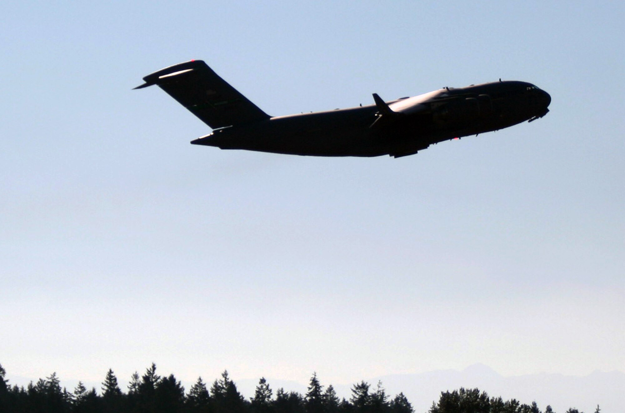 A C-17 Globemaster III from the 62nd Airlift Wing leaves for a mission from Joint Base Lewis-McChord, Wash., in preparation for Air Mobility Rodeo 2011 on July 23, 2011. Air Mobility Rodeo 2011, sponsored by the Air Mobility Command, is the Mobility Air Force's readiness competition. This competition focuses on improving our worldwide air mobility forces' professional core abilities. (U.S. Air Force Photo/Master Sgt. Scott T. Sturkol)