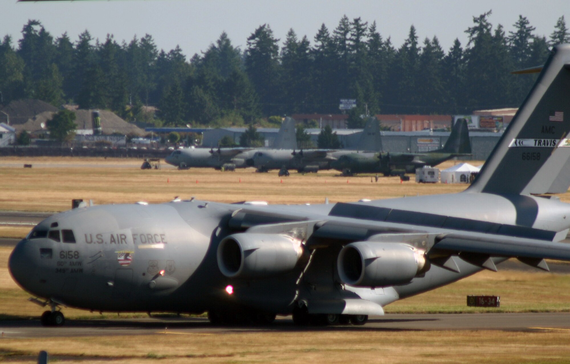 A C-17 Globemaster III from the 60th Air Mobility Wing at Travis Air Force Base, Calif., lands at Joint Base Lewis-McChord, Wash., as part of team arrivals for Air Mobility Rodeo 2011 on July 23, 2011. Air Mobility Rodeo 2011, sponsored by the Air Mobility Command, is the Mobility Air Force's readiness competition. This competition focuses on improving worldwide air mobility forces' professional core abilities. (U.S. Air Force Photo/Master Sgt. Scott T. Sturkol)