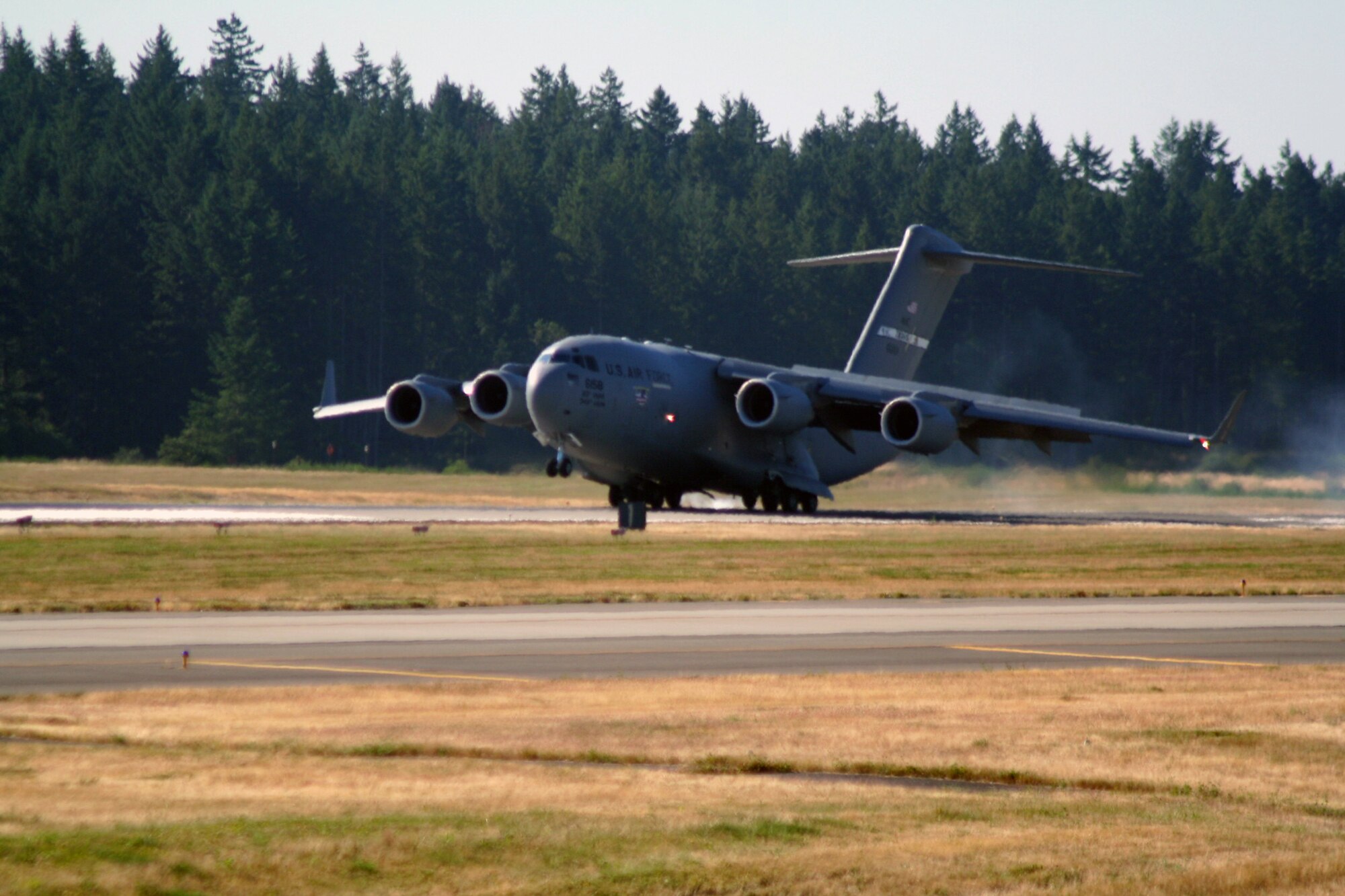 A C-17 Globemaster III from the 60th Air Mobility Wing at Travis Air Force Base, Calif., lands at Joint Base Lewis-McChord, Wash., as part of team arrivals for Air Mobility Rodeo 2011 on July 23, 2011. Air Mobility Rodeo 2011, sponsored by the Air Mobility Command, is the Mobility Air Force's readiness competition. This competition focuses on improving worldwide air mobility forces' professional core abilities. (U.S. Air Force Photo/Master Sgt. Scott T. Sturkol)