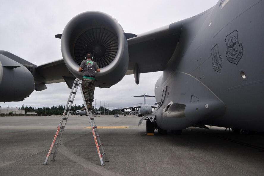 Tech. Sgt. Justin Dancer, 62nd Aircraft Maintenance Squadron Rodeo team member, conducts a C-17 Globemaster III foreign object inspection July 21, 2011, at Joint Base Lewis-McChord, Wash. Sergeant Dancer and his teammates have been preparing the C-17 for two months, fixing every minor discrepancy and eliminating all foreign object debris. They will compete in Air Mobility Rodeo 2011, sponsored by the Air Mobility Command, which is the Mobility Air Force's premier readiness competition. This competition focuses on improving our worldwide air mobility forces' professional core abilities. (U.S. Air Force Photo/Airman 1st Class Leah Young)
