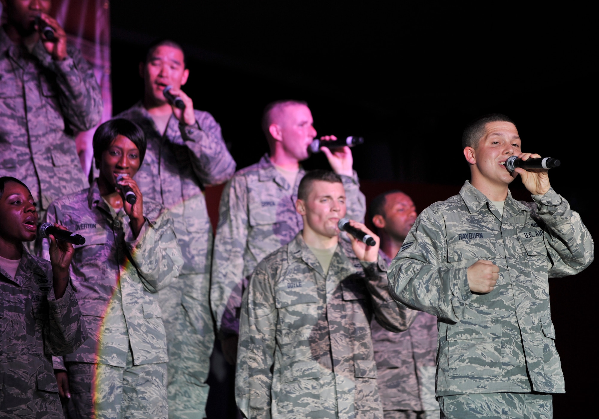 Senior Airman Zachery Rayburn (far right), Tops in Blue vocalist, sings along with other Tops in Blue members during a performance in Southwest Asia, July 22. This year’s tour takes the performers to more than 20 countries, with close to 140 performances in a 10-month period. (U.S. Air Force photo/Senior Airman Paul Labbe)