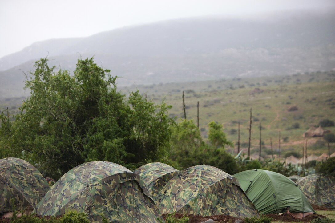 Camouflage and olive-drab two-man tents are set up in an area of 6th South African Infantry Battalion Field Training Area as part of Exercise Shared Accord 2011. Shared Accord is a bi-lateral military training exercise and humanitarian mission held annually throughout Africa. This year, the exercise brings together about 700 U.S. service members, most from the U.S. Marine Corps Reserve, and double that number in South African National Defense Force troops.  (Official Marine Corps photo by Cpl. Jad Sleiman)