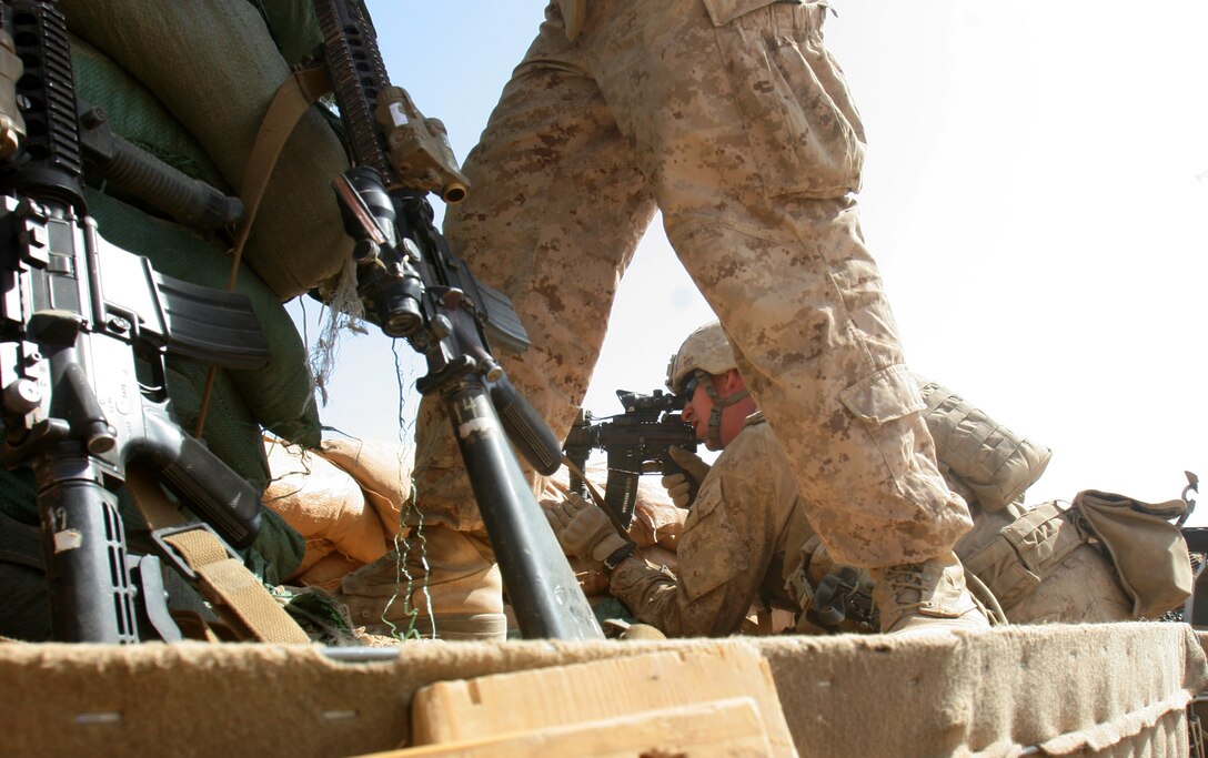 Lance Cpl. Paul Gammon, an assaultman team leader with 3rd Platoon, Company K, 3rd Battalion, 4th Marines, sights in on insurgents during an attack on Patrol Base Kakar, Afghanistan July 24.  “We started taking fires from compounds 50 and 52. So, we returned fire and gained fire superiority,” said Gammon, a native of Tampa, Fla. who graduated from Riverview High School in 2007.  “This deployment has been a lot more kinetic than last deployment.”
