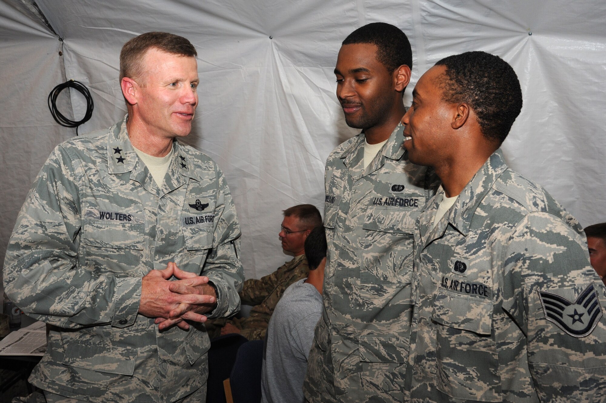Staff Sgt. George Munyiri (r) and Senior Airman Miguel Copeland discuss the amenities available to transient servicemembers at Lobos Recreation Center with Maj. Gen. Tod Wolters during his visit to the Transit Center at Manas, Kyrgyzstan, July 24. Munyiri and Copeland are both 376th Expeditionary Force Support Squadron quality assurance evaluators deployed here from Travis Air Force Base, Calif. Wolters is the commander of the 9th Air and Space Expeditionary Task Force - Afghanistan and deputy commander for air at U.S. Forces-Afghanistan. (U.S. Air Force photo/Tech. Sgt. Hank Hoegen)