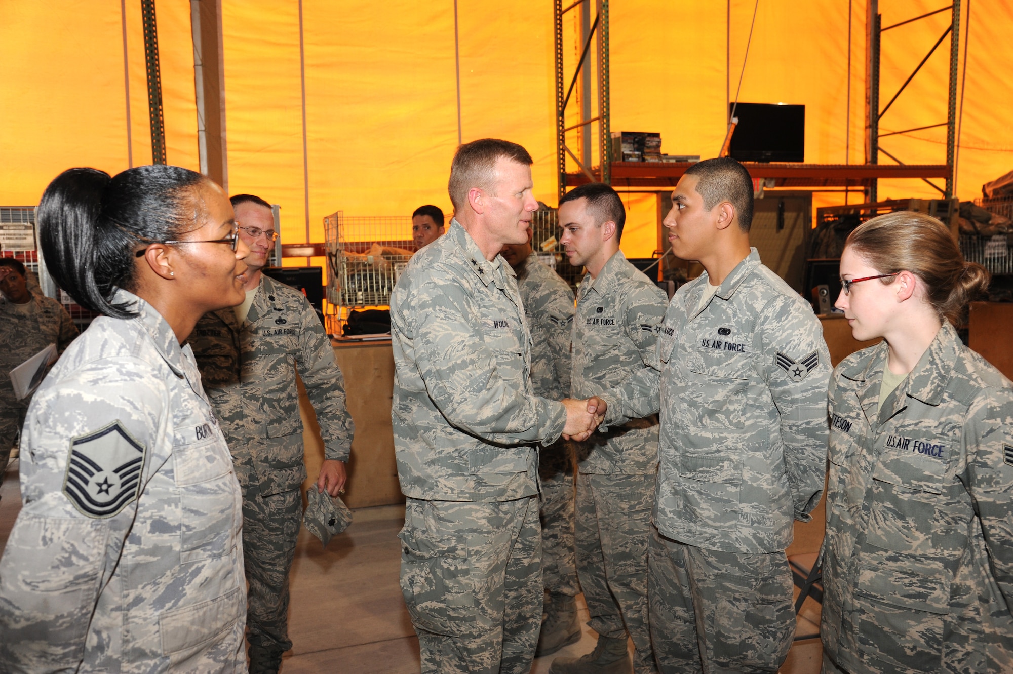Maj. Gen. Tod Wolters shakes hands with Airmen who work in the 376th Expeditionary Logistics Readiness Squadron Expeditionary Theater Distribution Center at the Transit Center at Manas, Kyrgyzstan, July 24. Wolters is the commander of the 9th Air and Space Expeditionary Task Force - Afghanistan and deputy commander for air at U.S. Forces-Afghanistan. He visited here to observe how transient servicemembers process through the Transit Center. (U.S. Air Force photo/Tech. Sgt. Hank Hoegen)