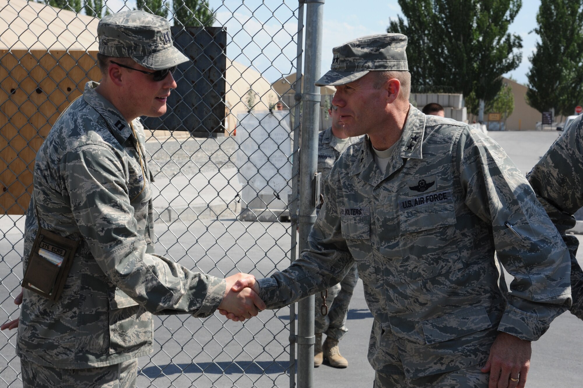 Capt. Jared Eros greets Maj. Gen. Tod Wolters as he arrives at the 376th Expeditionary Logistics Readiness Squadron baggage yard July 24. Eros is an operations officer deployed to the Transit Center at Manas, Kyrgyzstan, from Travis Air Force Base, Calif. Wolters is the commander of the 9th Air and Space Expeditionary Task Force - Afghanistan and deputy commander for air at U.S. Forces-Afghanistan. (U.S. Air Force photo/Tech. Sgt. Hank Hoegen) 