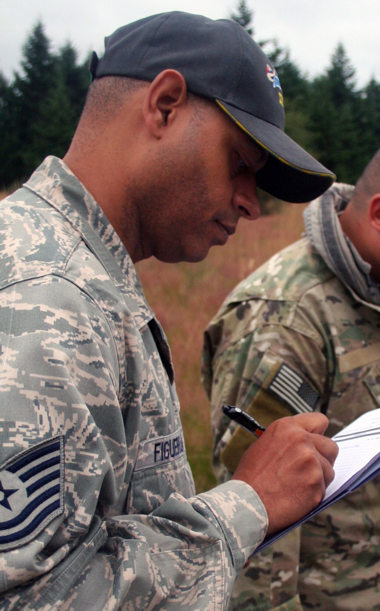 Tech. Sgt. Victor Figueroa, Air Mobility Rodeo 2011 umpire from the 421st Combat Training Squadron at the U.S. Air Force Expeditionary Center on Joint Base McGuire-Dix-Lakehurst, N.J., reviews checklists for the Rodeo security forces combat tactics event at Joint Base Lewis-McChord, Wash., on July 25, 2011. (U.S. Air Force Photo/Master Sgt. Scott T. Sturkol)