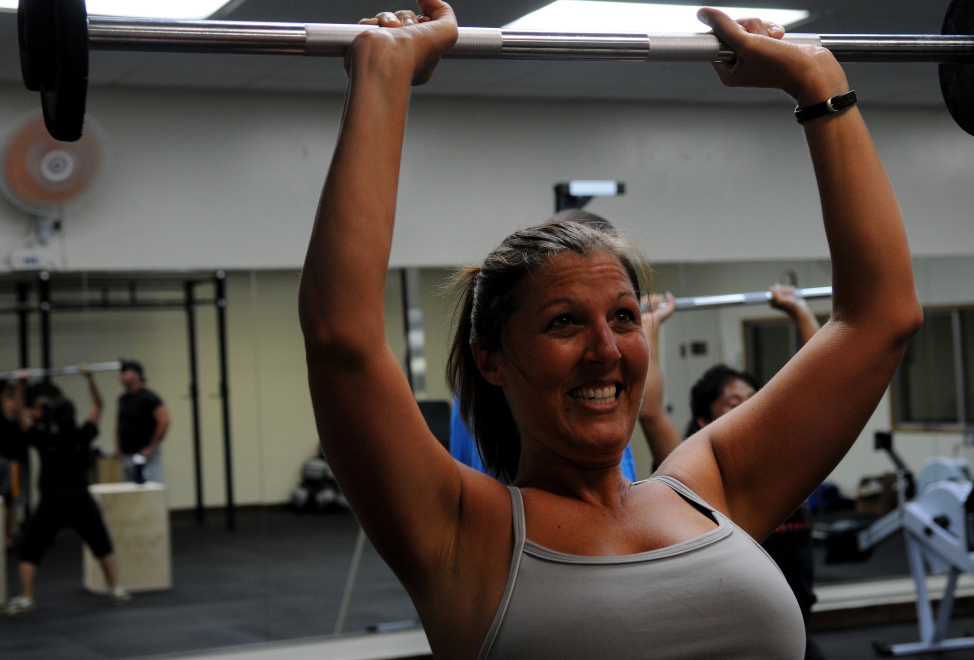 Ilene Morrison, 525th Electronic Maintenance Squadron sheet metal mechanic, performs a shoulder press exercise July 25 at Shogun Crossfit inside the Risner Fitness Complex. Free Crossfit classes started July 25 and take place Monday through Friday at 6 a.m. and 5 p.m.. A requirement to enroll in the classes is to complete a mandatory fundamentals course that introduces the program, proper form and methodology. (U.S. Air Force photo/Airman 1st Class Jarvie Z. Wallace)