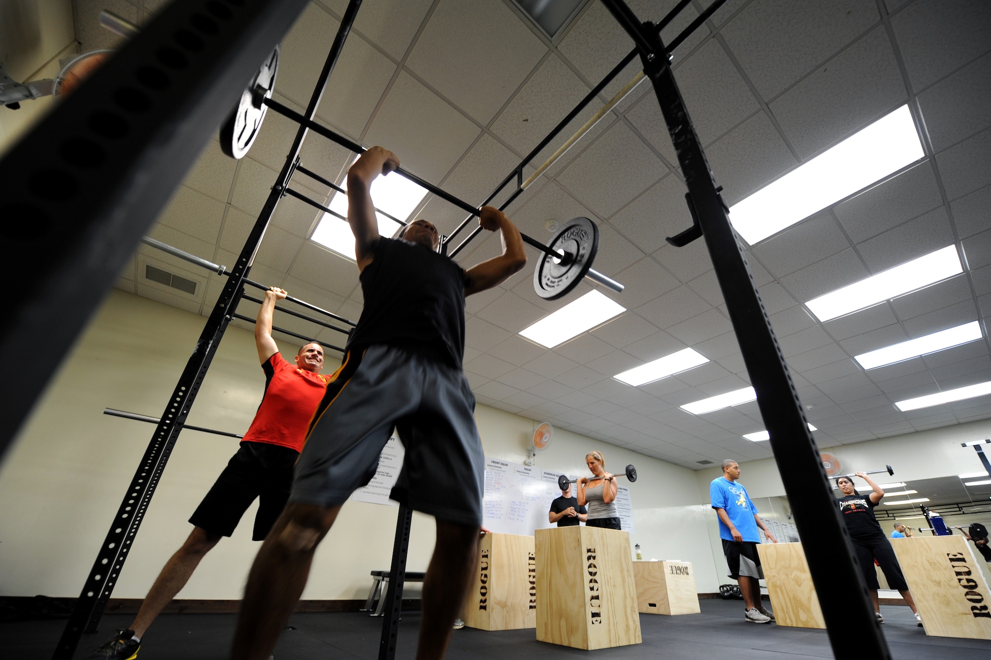 Crossfit members participate in a series of shoulder exercises July 25 at Shogun Crossfit  inside the Risner Fitness Complex. Free Crossfit classes started July 25 and take place Monday through Friday at 6 a.m. and 5 p.m.. A requirement to enroll in the classes is to complete a mandatory fundamentals course that introduces the program, proper form and methodology. (U.S. Air Force photo/Airman 1st Class Jarvie Z. Wallace)
