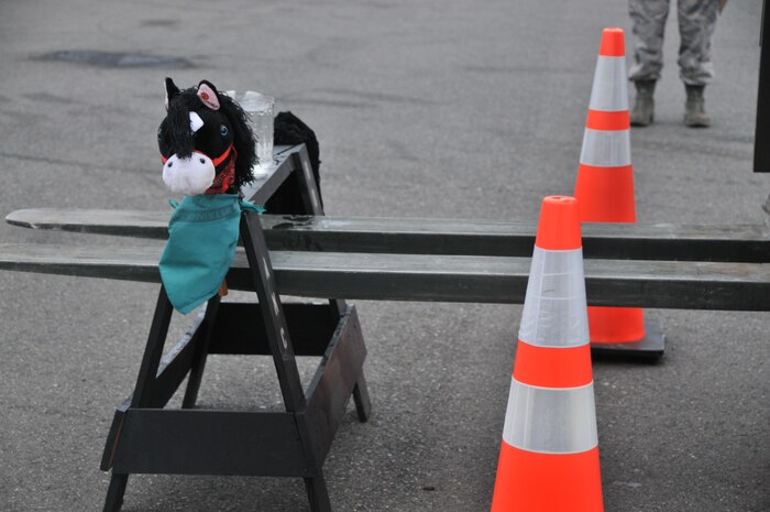 A forklift driver unloads a wooden horse holding a pitcher of water during a forklift driving course, July 25, 2011, at Joint Base Lewis-McChord, Wash. The event was part of Air Mobility Rodeo 2011, a biennial international competition that focuses on mission readiness, featuring airdrops, aerial refueling and other events that showcase the skills of mobility crews from around the world. (U.S. Air Force photo/ Airman 1st Class Jared Trimarchi) 

