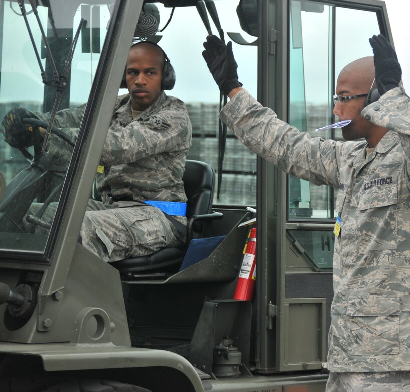 Two Airmen work together to complete a forklift driving course, July 25, 2011 at Joint Base Lewis-McChord. The event was part of Air Mobility Rodeo 2011, a biennial international competition that focuses on mission readiness, featuring airdrops, aerial refueling and other events that showcase the skills of mobility crews from around the world. (U.S. Air Force photo/ Airman 1st Class Jared Trimarchi) 

