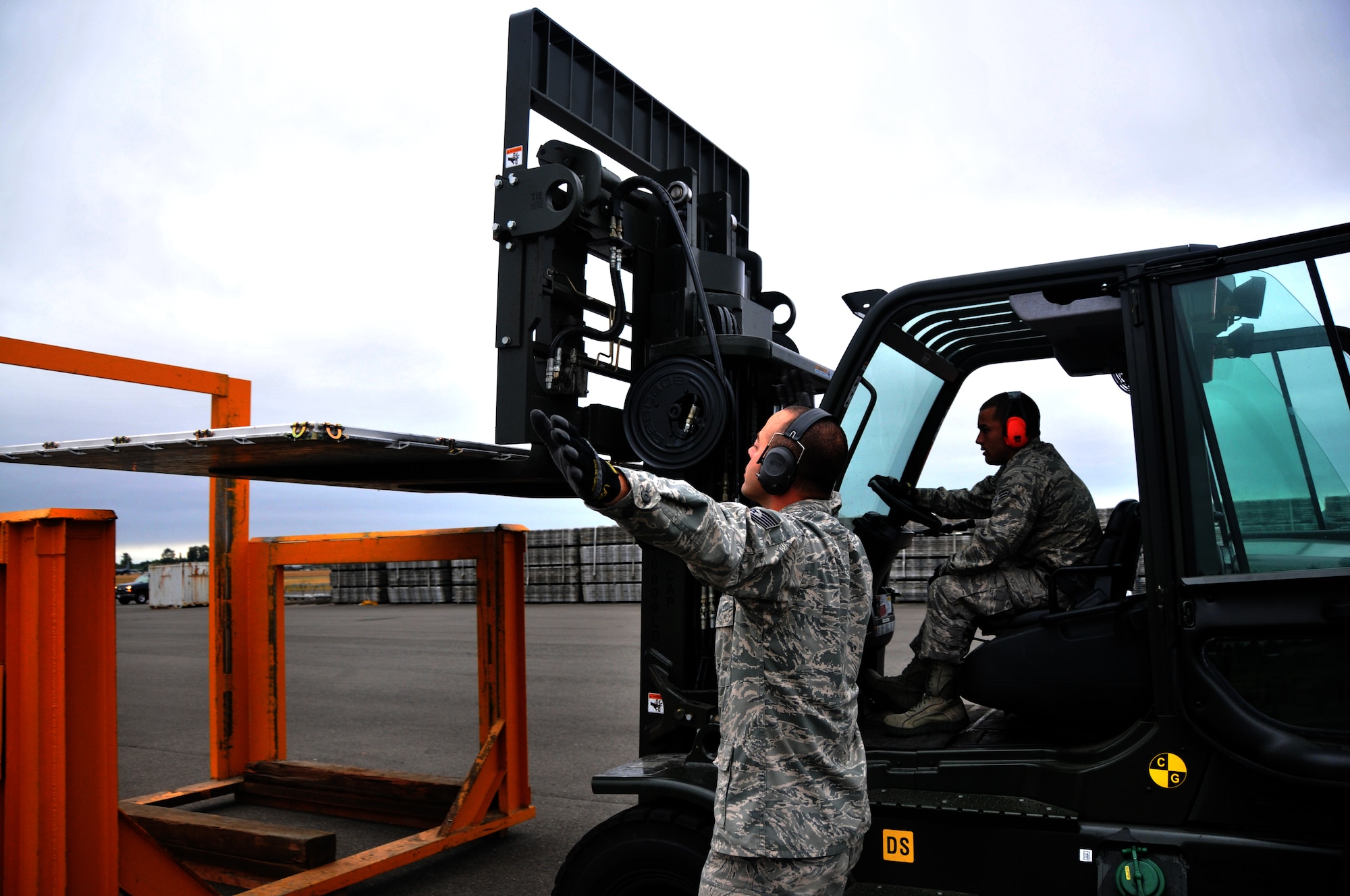 Two Airmen unload a pallet into a pallet stacker during a forklift driving course, July 25, 2011, at Joint Base Lewis-McChord, Wash. The event was part of Air Mobility Rodeo 2011, a biennial international competition that focuses on mission readiness, featuring airdrops, aerial refueling and other events that showcase the skills of mobility crews from around the world. (U.S. Air Force photo/ Airman 1st Class Jared Trimarchi) 

