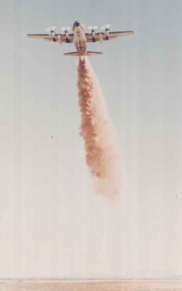 Kirtland Air Force Base, N.M.  A MAFFs-equiped C-130 aircraft dispenses flame retardant. MAFFS were developed by the Air Force Weapons Laboratory, now the Air Force Research Laboratory, at Kirtland AFB in 197. MAFFS recently staged at Kirtland AFB to help with local wildfires. (courtesy photo)