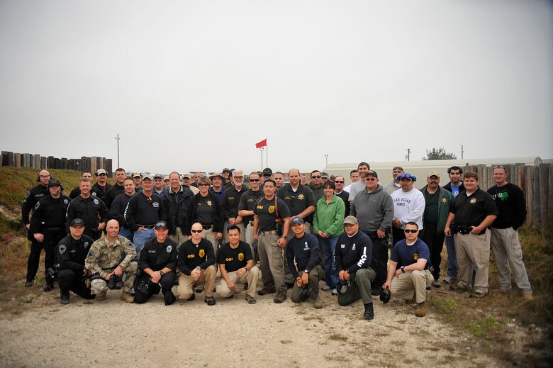 VANDENBERG AIR FORCE BASE, Calif. -- Members from federal, state and local law enforcement agencies pose for a group photo during the 4th Annual Bowling Pin Shootout at the Rod and Gun Club here Friday, July 22, 2011.  The Office of Special Investigations sponsored the event to help build relationships between different law enforcement agencies.  (U.S. Air Force photo/Staff Sgt. Andrew Satran) 

 