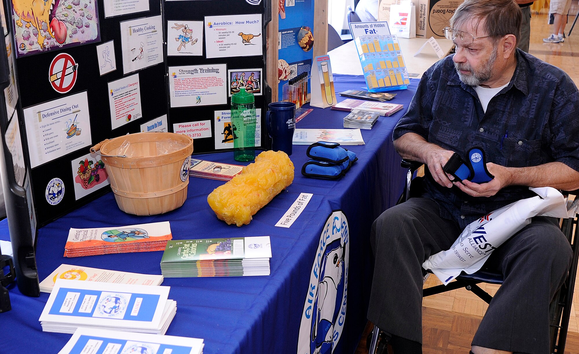 A visitor to the Front Range Retiree Appreciation Day checks out a Health and Wellness Center display set up by the Air Force Academy's HAWC staff July 23, 2011. The event featured speakers from each of the local bases' host wings as well as Academy Superintendent Lt. Gen. Mike Gould. (U.S. Air Force photo/Mike Kaplan)
