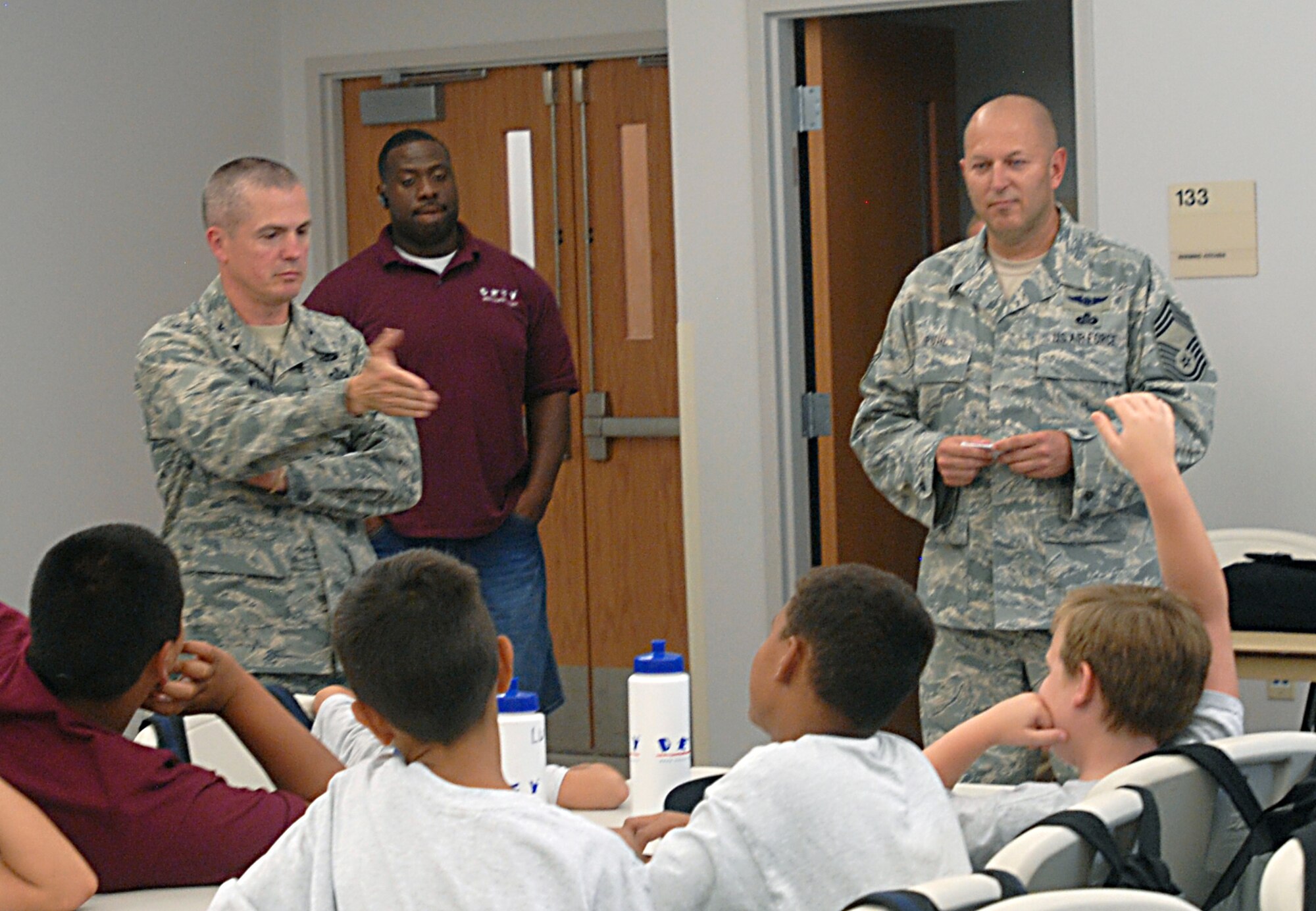 GOODFELLOW AIR FORCE BASE, Texas -- Col. JD Willis, 17th Training Group Commander, and Chief Master Sgt. Robert Puhl, 17th TRG Superintendent, speaks to DEFY Camp youths about how to set and achieve goals July 19. (U.S. Air Force photo/Connie Hempel)