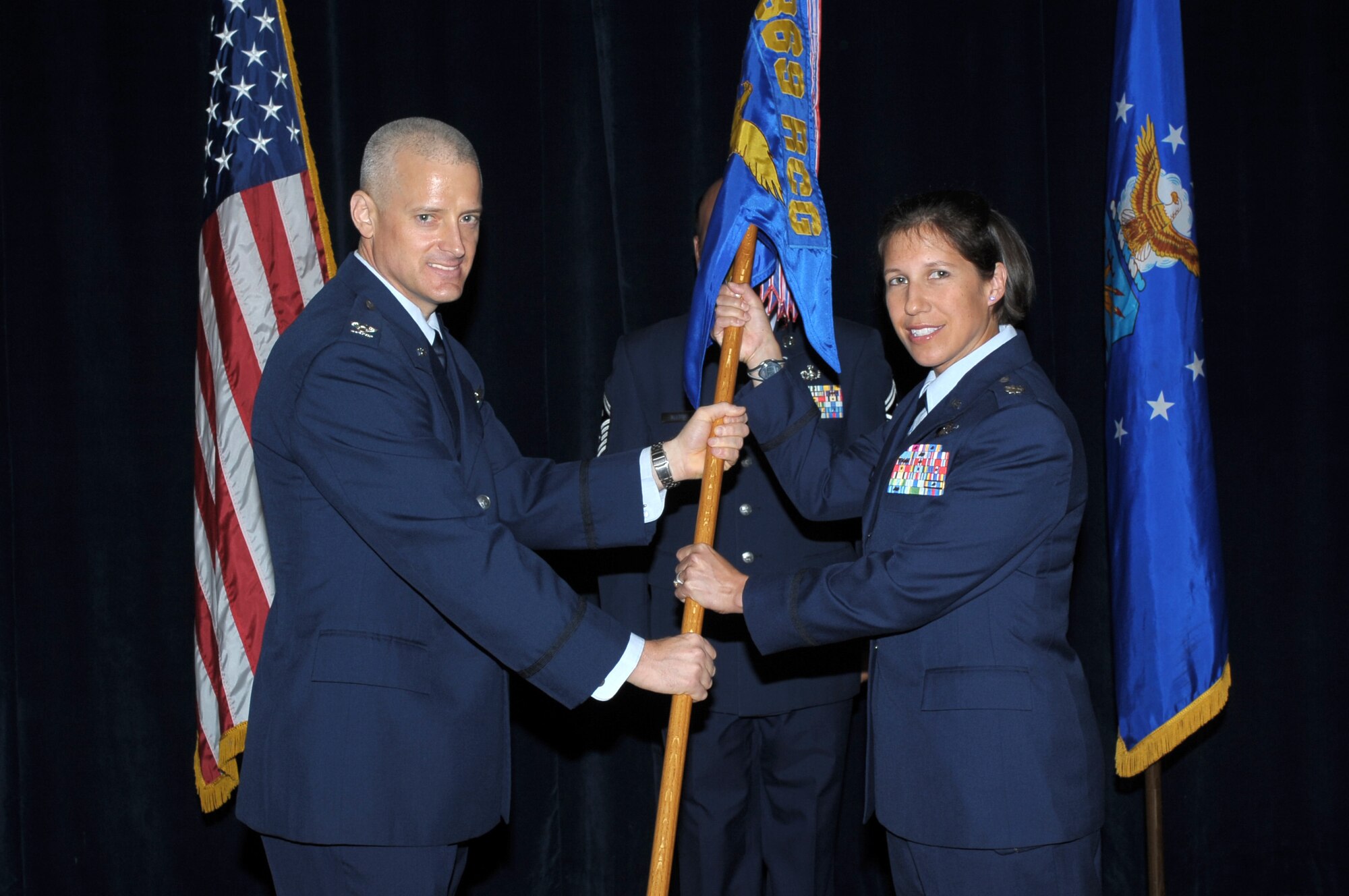 Col. Kent Dalton, 369th Recruiting Group commander (left), presents the 341st Recruiting Squadron guidon to Lt. Col. Jessica Nichol (right) during a change of command ceremony July 7. Nichol leads the 341st RCS and is responsible for the accession of high-quality recruits to meet Air Force enlistments, health professions, and line officers needs, and manages a $1.4 million budget, 118 vehicles, and 62 recruiting offices supporting the annual accession of more than 1,400 recruits each year. (U.S. Air Force photo/courtesy photo)