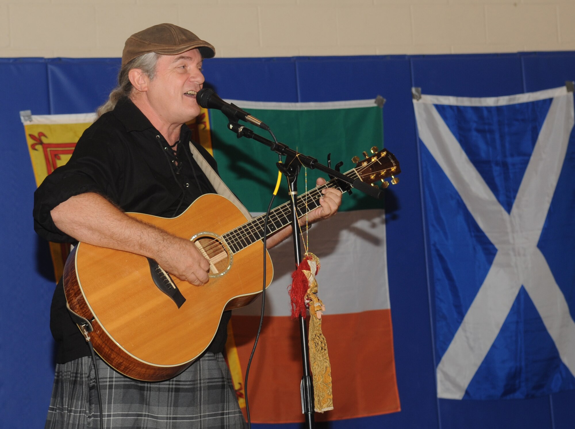Rickey Pittman, storyteller, author and folksinger, sings Celtic folk songs to the children at the youth center for the finale of the Summer Reading Program on Barksdale Air Force Base, La., July 19. This year, the Summer Reading Program had 174 participants who read to receive prizes such as bikes and teddy bears. (U.S. Air Force photo/Senior Airman Kristin High)(RELEASED)