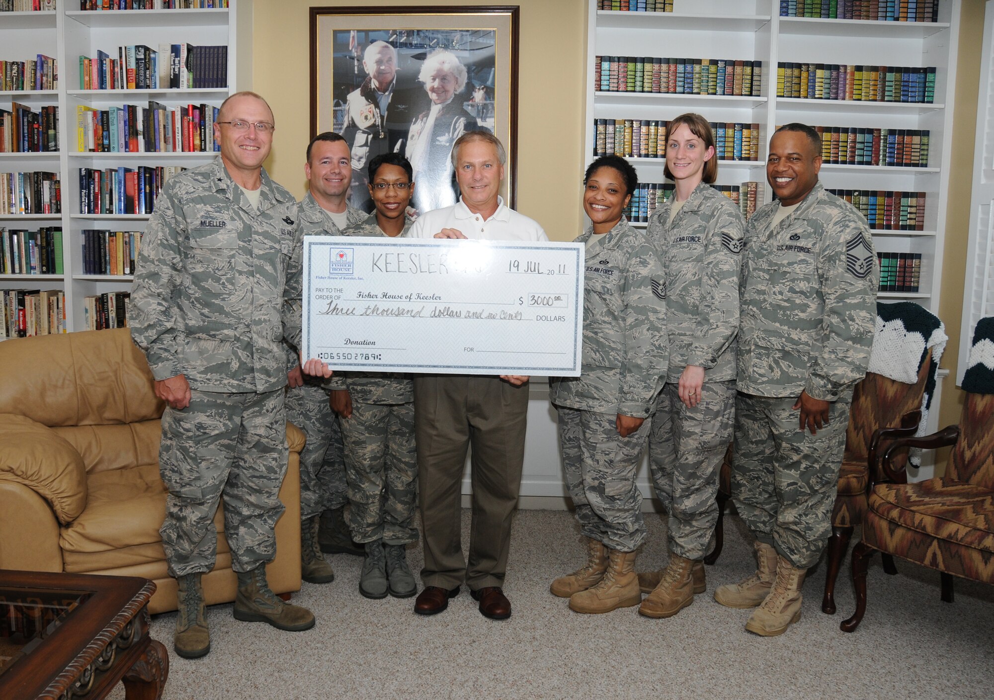 From left, Brig. Gen. Andrew Mueller, 81st Training Wing commander; Tech. Sgt. Richard Striggow, 333rd Training Squadron; Staff Sgt. Serena Ellis, 335th TRS; Larry Vetter, Fisher House director; Tech. Sgt. Debbie Jackson, 334th TRS; SSgt Christina Gagnon, 81st Medical Group; and Chief Master Sgt. Curtis Jennings, 81st TRW command chief, pose for a photo with a check presented by the Keesler 5/6 for $3,000.00.  The contribution to the Keesler Fisher House was raised from the 12-hour Dragon Challenge event held by the Keesler 5/6 June 10.  Striggow is the Keesler 5/6 president.  (U.S. Air Force photo by Kemberly Groue)