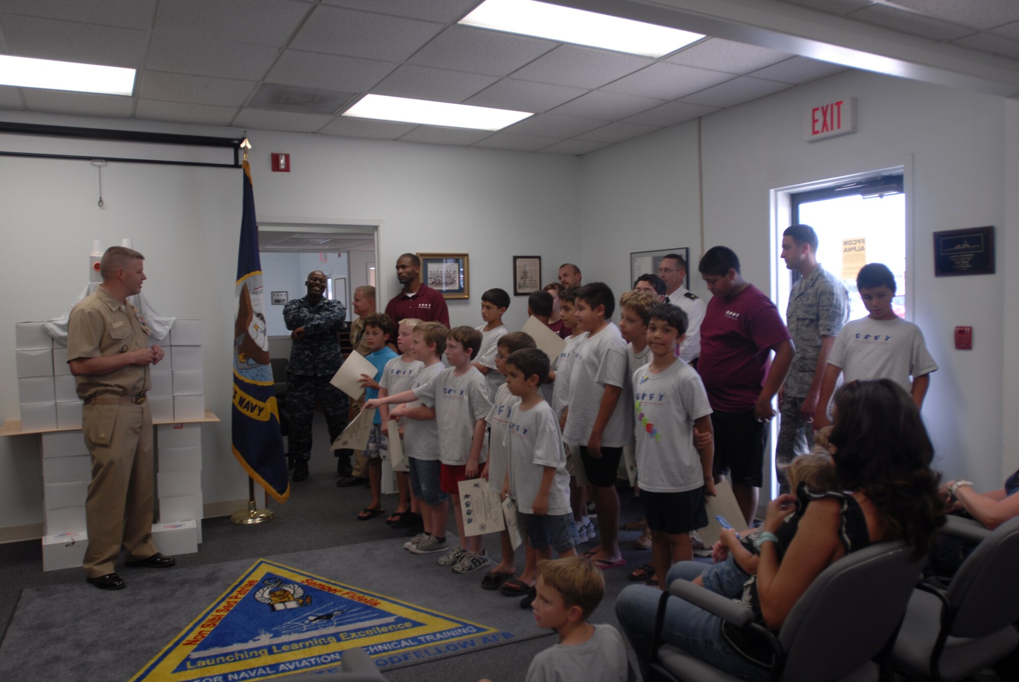 GOODFELLOW AIR FORCE BASE, Texas—Navy Lt. Lonnie Griffith, Navy Center for Information Dominance Detachment Officer in Charge, speaks to DEFY camp graduates July 20 at the Navy Detachment. The free camp is open to the children of all Defense Department personnel. For more information, contact the Navy Detachment at (325) 654-3574 and ask about the DEFY program. (U.S. Air Force photo/Airman 1st Class Jessica Keith)