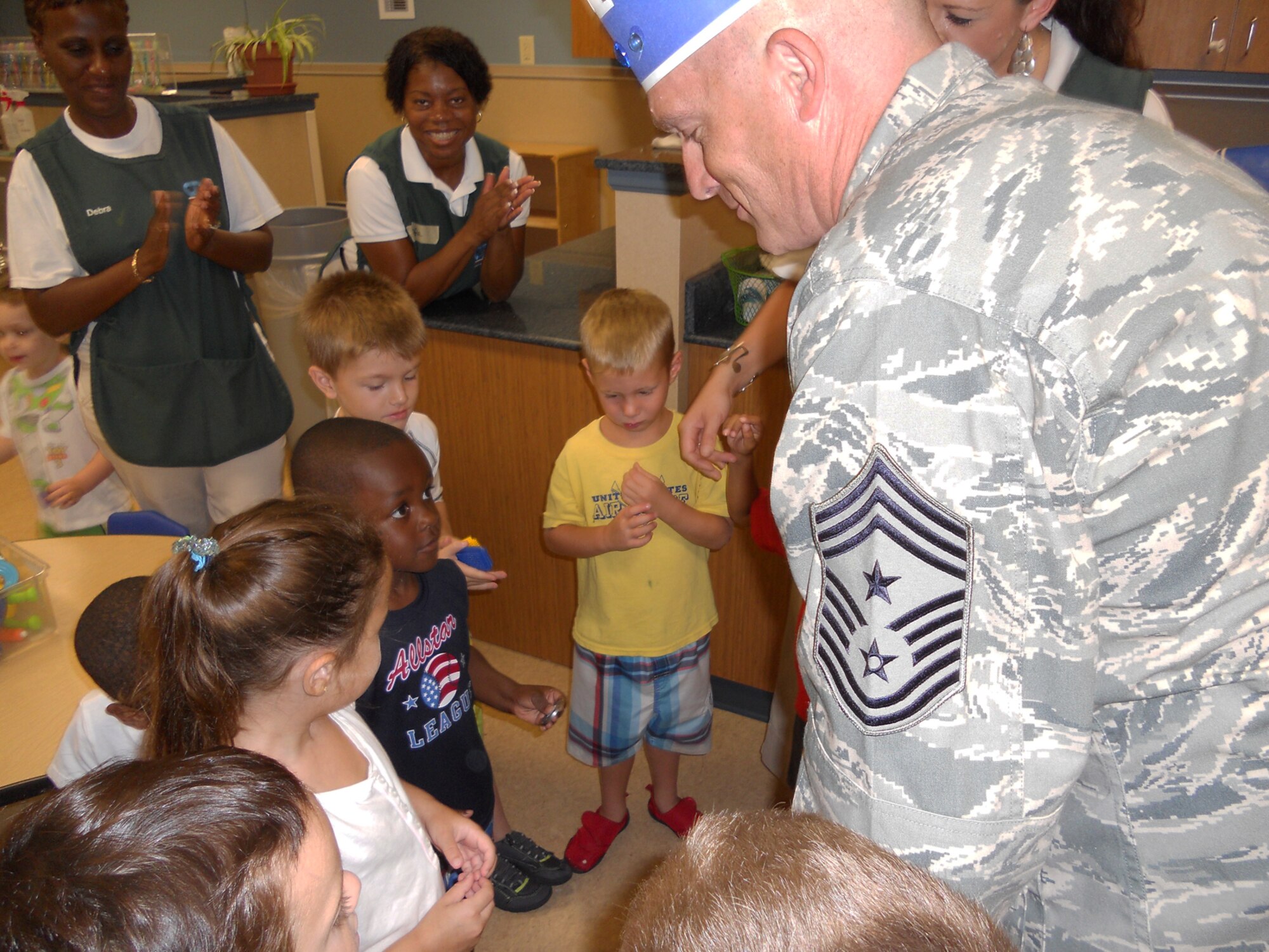 U.S. Air Force Chief Master Sgt. Robert Brooks, 9th Air Force command chief, visits with children at the Child Development Center at Moody Air Force Base, Ga., July 15, 2011. During his tour of the base, Chief Brooks also got a look at the new CDC, which will provide room for nearly 280 Moody children. (U.S. Air Force photo by Chief Master Sgt. Frank Batten/Released)