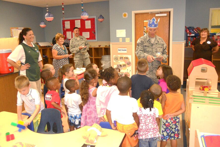 U.S. Air Force Chief Master Sgt. Robert Brooks, 9th Air Force command chief, interacts with children at the Child Development Center at Moody Air Force Base, Ga., July 15, 2011. Because it was the chief’s birthday, the kids made him cards and a birthday crown. (U.S. Air Force photo by Chief Master Sgt. Frank Batten/Released)