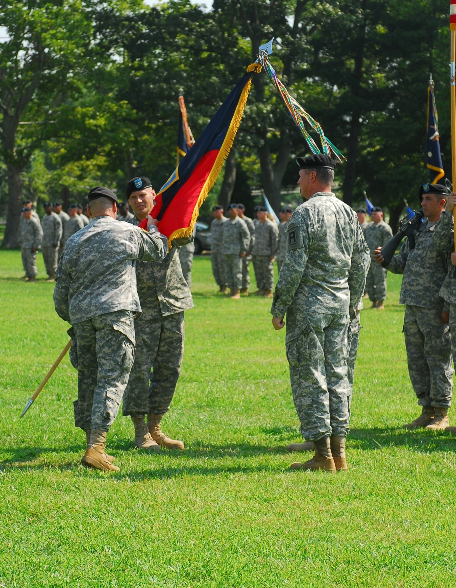 Col. Craig Osborne, 174th Infantry Brigade incoming commander, receives the unit colors from Maj. Gen. Kevin R. Wendel, First Army Division East commander, during a change of command ceremony at Sharp Field at Joint Base McGuire-Dix-Lakehurst July 19.  (U.S. Army photo by Sgt. 1st Class Amy Mueller/Released).  