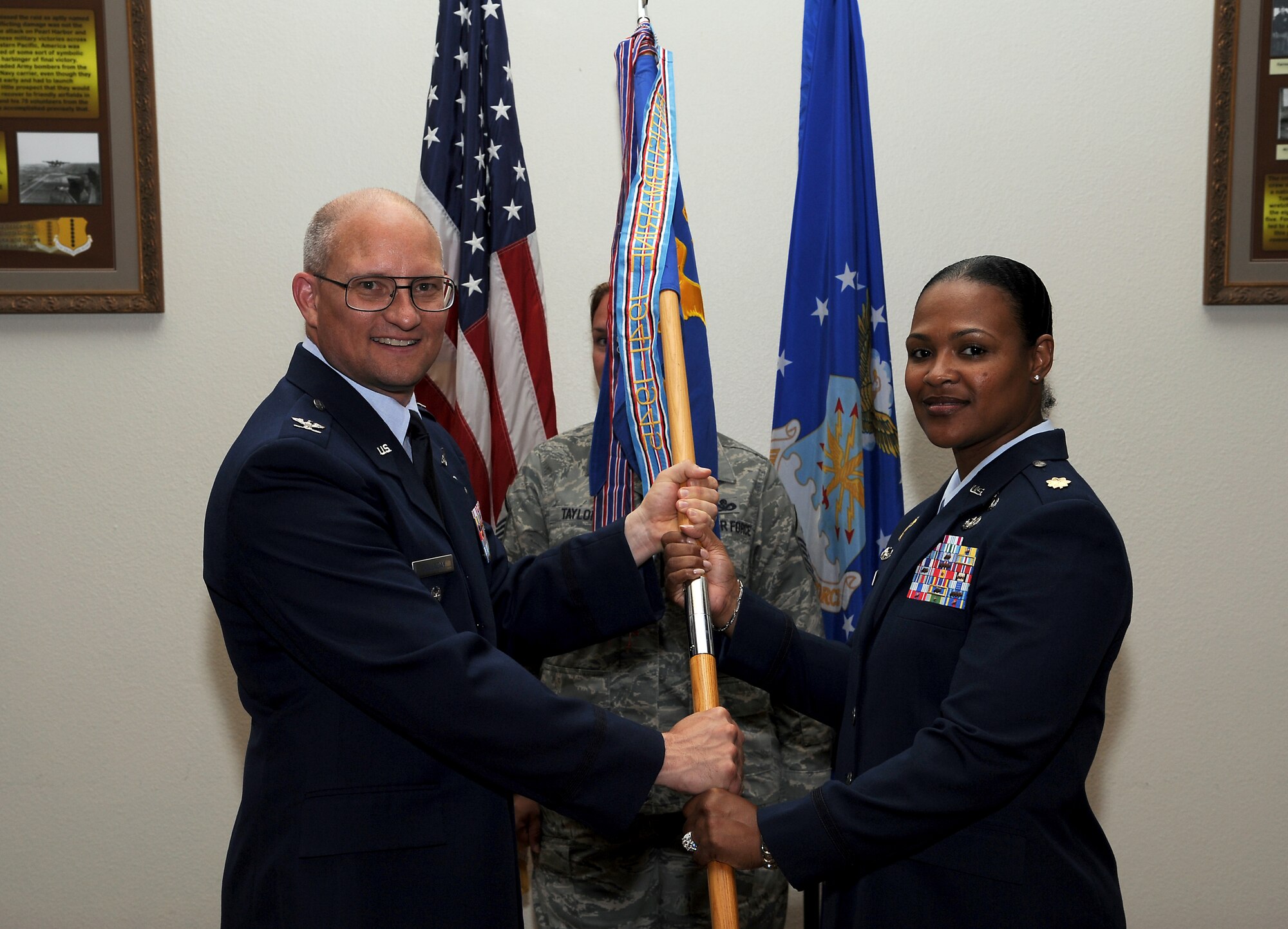 GOODFELLOW AIR FORCE BASE, Texas-- (From left:) Col. William Golladay, 17th Training Wing Vice Commander, passes the 17th Comptroller Squadron guidon to Maj. Yolanda Taylor, who assumed command of the 17th CPTS from Maj. Michael Goodman during a change of command ceremony July 22 at the Events Center here. (U.S. Air Force photo/Airman 1st Class Michael Smith)
