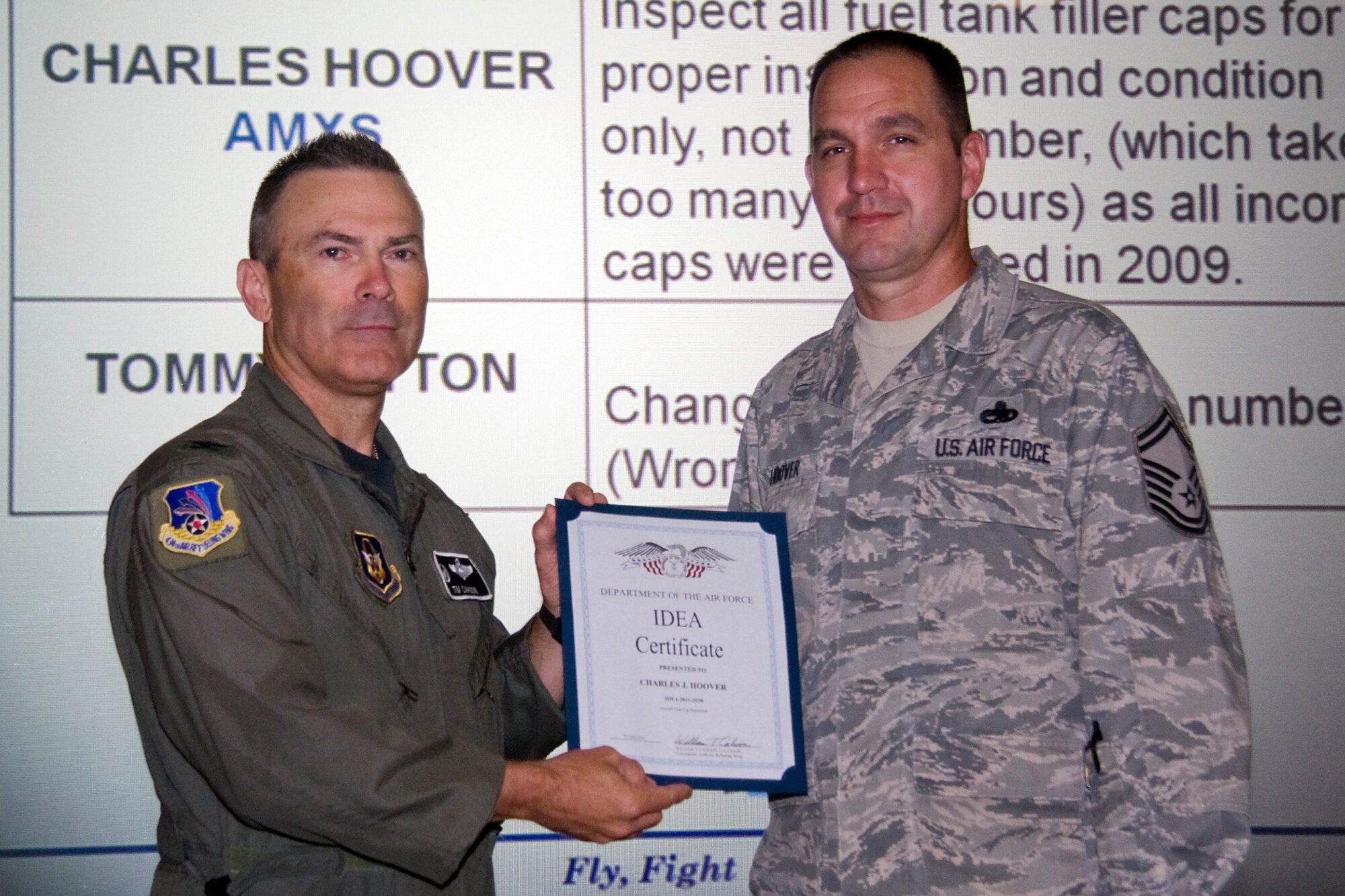 Senior Master Sgt. Charles Hoover, 434th Aircraft Maintenance Squadron flight chief, receives his Air Force Innovative Development through Employee Awareness Program, or IDEA, award from Col. William T. "Tim" Cahoon, 434th Air Refueling Wing commander.  Hoover's IDEA submission was to inspect all fuel tank filler caps for proper installation and condition only, not part number, which takes too many man hours as all incorrect caps were replaced in 2009. The IDEA Program is an incentive program that promotes process improvement and resource savings through ideas submitted by military and civilian employees. (U.S. Air Force photo/Tech. Sgt. Mark R. W. Orders-Woempner)

