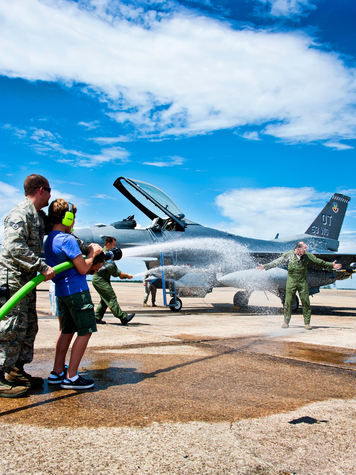 Col. Michael Gantt, the 53rd Wing commander, gets sprayed down by his children and others after his final flight at commander of the wing July 22 at Eglin Air Force Base, Fla.  Gantt leaves the wing for a position with Air Force A5 at the Pentagon.  (U.S. Air Force photo/Samuel King Jr.)