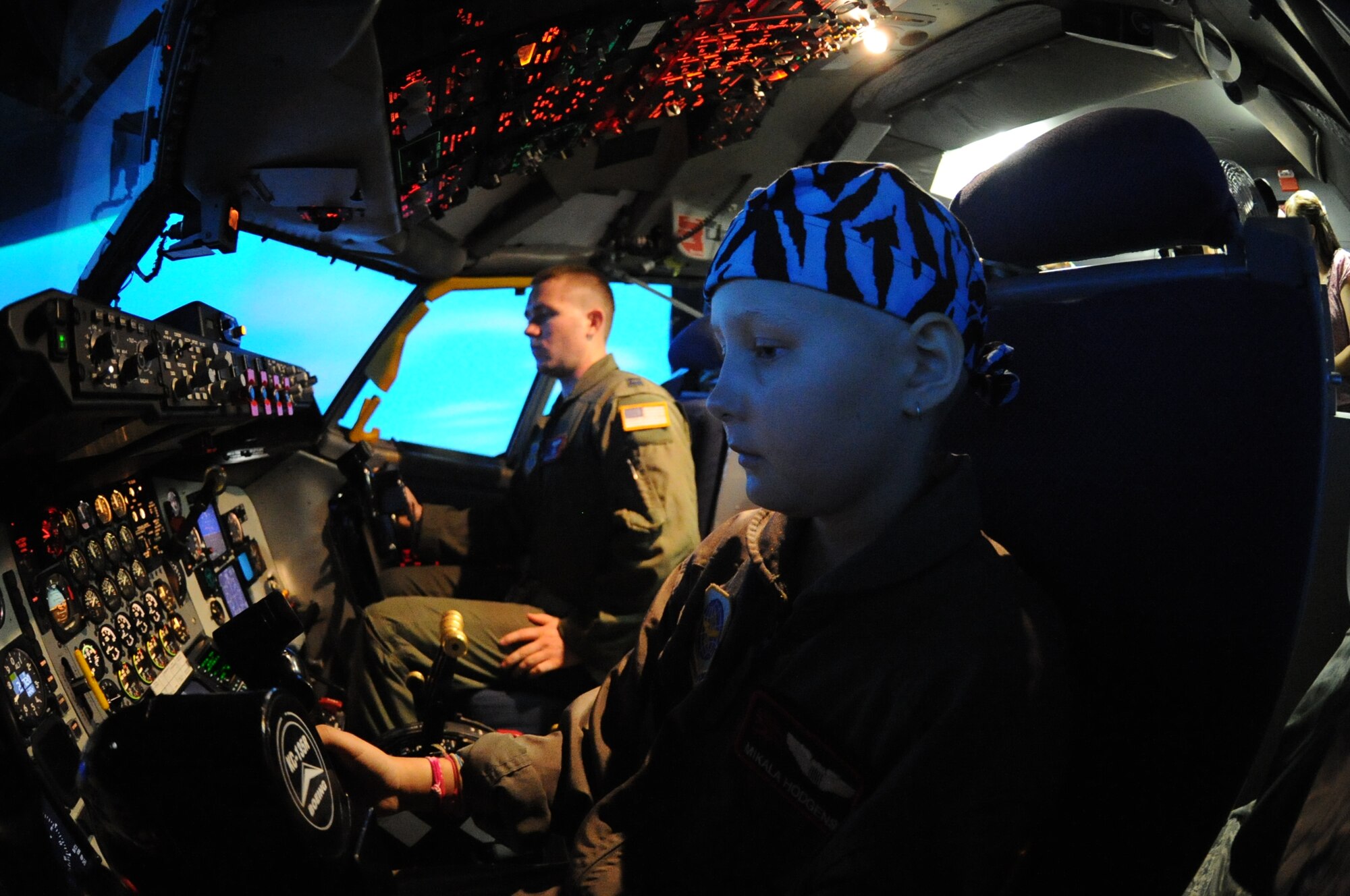 MCCONNELL AIR FORCE BASE, Kan.  – Mikala Hodgens, from Wichita, Kan., flies the KC-135 Stratotanker simulator with a member of the 350th Air Refueling Squadron July 20, 2011, McConnell Air Force Base, Kan.  Mikala flew the simulator, toured the fire department and military working dog facility as part of the Pilot for a Day program.  (U.S. Air Force photo/ Airman 1st Class Katrina M. Brisbin)