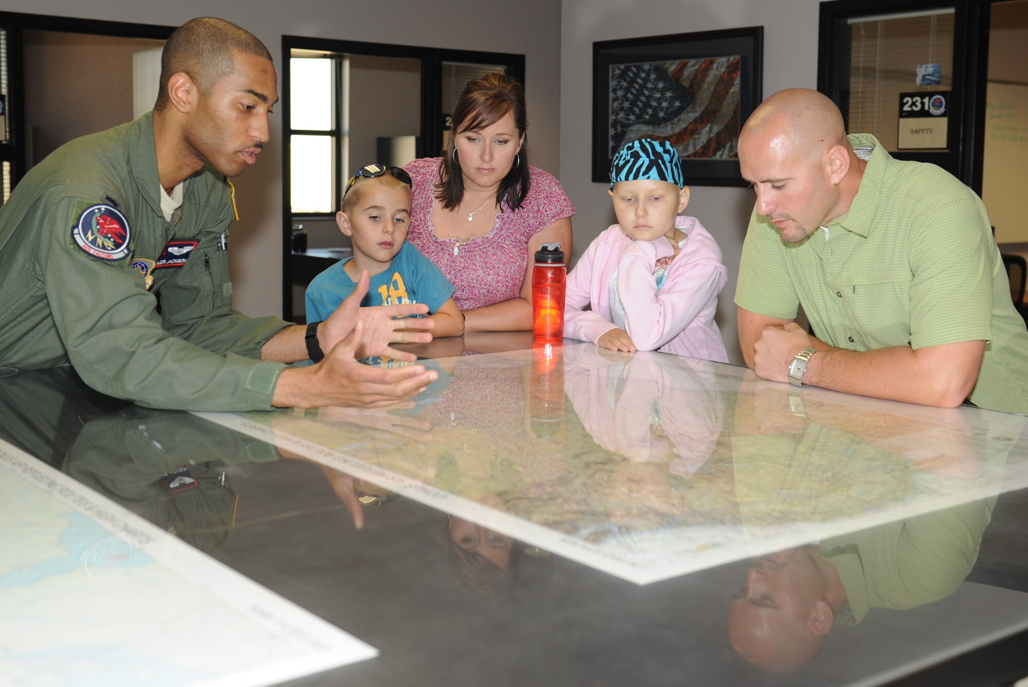 MCCONNELL AIR FORCE BASE, Kan.  – 1st Lt. Tyler Jackson, 350th Air Refueling Squadron navigator, explains the mission of the 22nd Air Refueling Wing to the Hodgens family of Wichita, Kan., July 20, 2011, McConnell Air Force Base, Kan.  The Hodgens’ were hosted for the day by the 350th Air Refueling Squadron as part of the Pilot for a Day program.  (U.S. Air Force photo/ Airman 1st Class Katrina M. Brisbin)