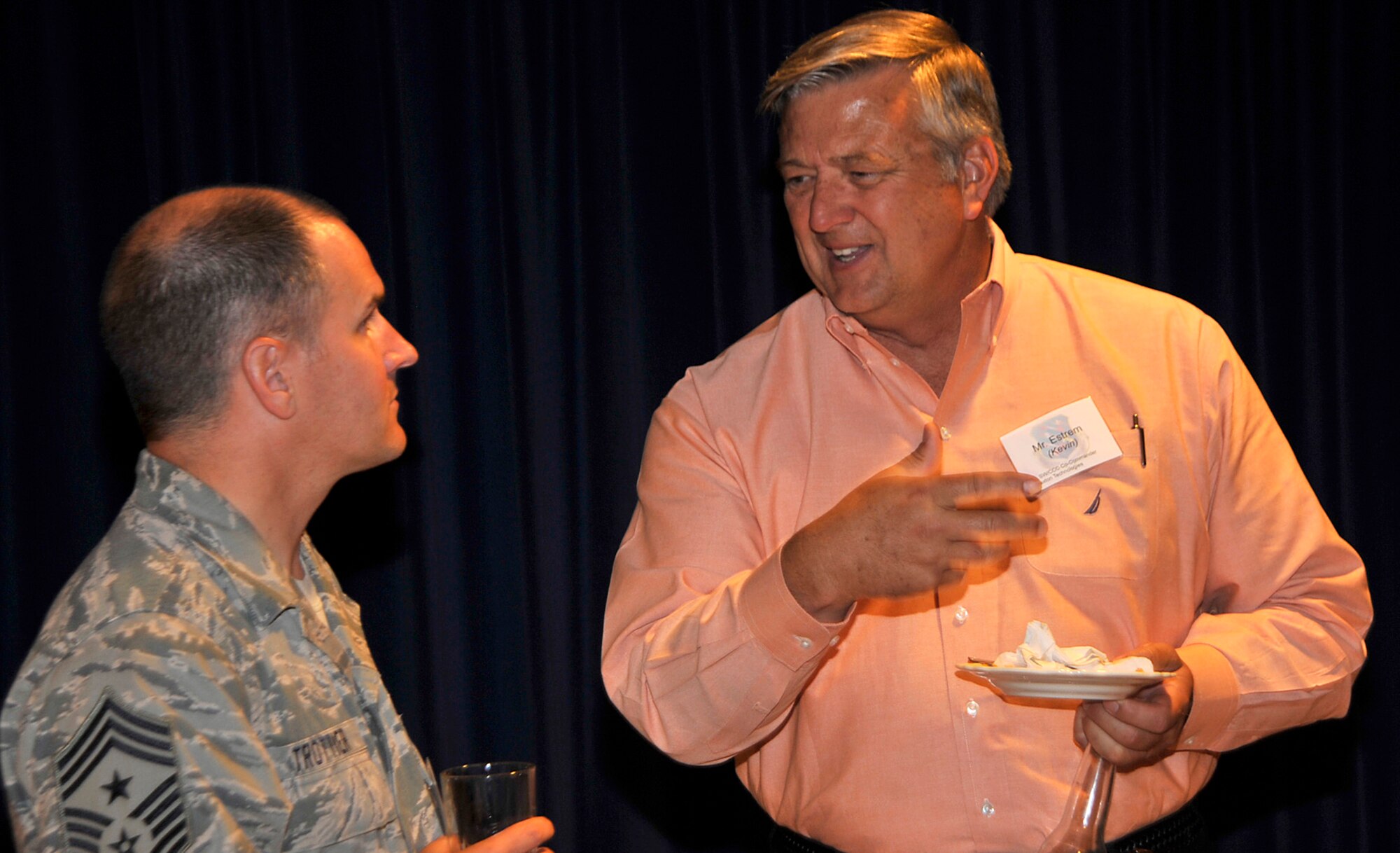 PETERSON AIR FORCE BASE, Colo. –Chief Master Sgt. Thomas Trottier (left), 21st Space Wing command chief, speaks with Kevin Estrem, Braxton Technologies, during the commander’s social July 19, 2011 at The Club. Col. Chris Crawford, 21st Space Wing commander, hosted the event to foster community relations with Colorado Springs leaders, and increase awareness and understanding of the 21st SW mission. (U.S. Air Force photo/Dennis Howk)
