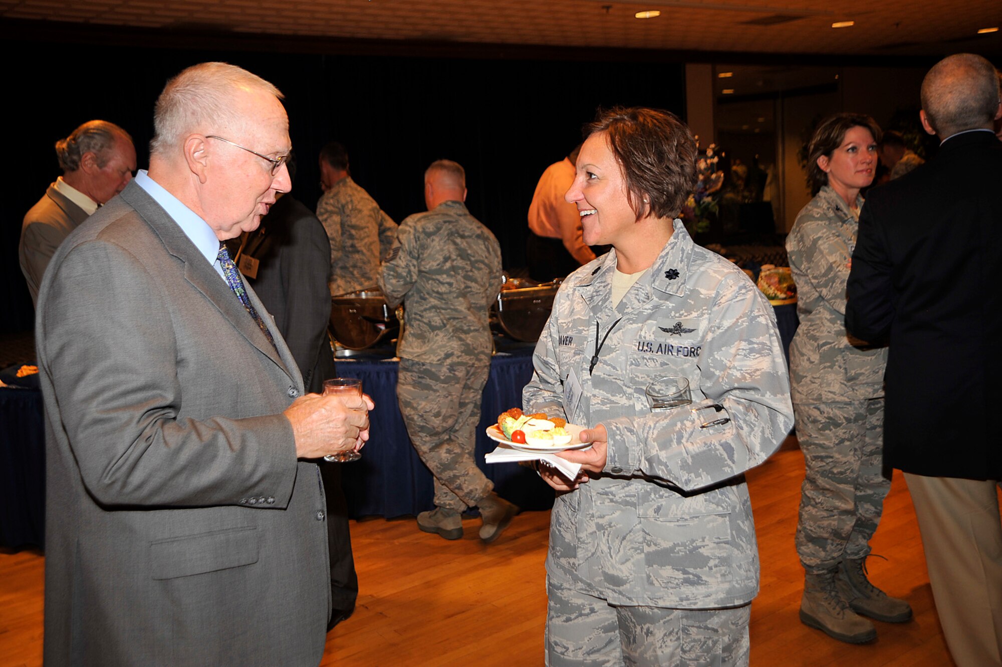 PETERSON AIR FORCE BASE, Colo. –Bob Peterson (left), formerly with Lockheed Martin, and Lt. Col. Kathy Craver, 21st Communications Squadron commander, get acquainted during the commander’s social July 19, 2011 at The Club. Col. Chris Crawford, 21st Space Wing commander, hosted the event to foster community relations with Colorado Springs leaders, and increase awareness and understanding of the 21st SW mission. (U.S. Air Force photo/Dennis Howk)
